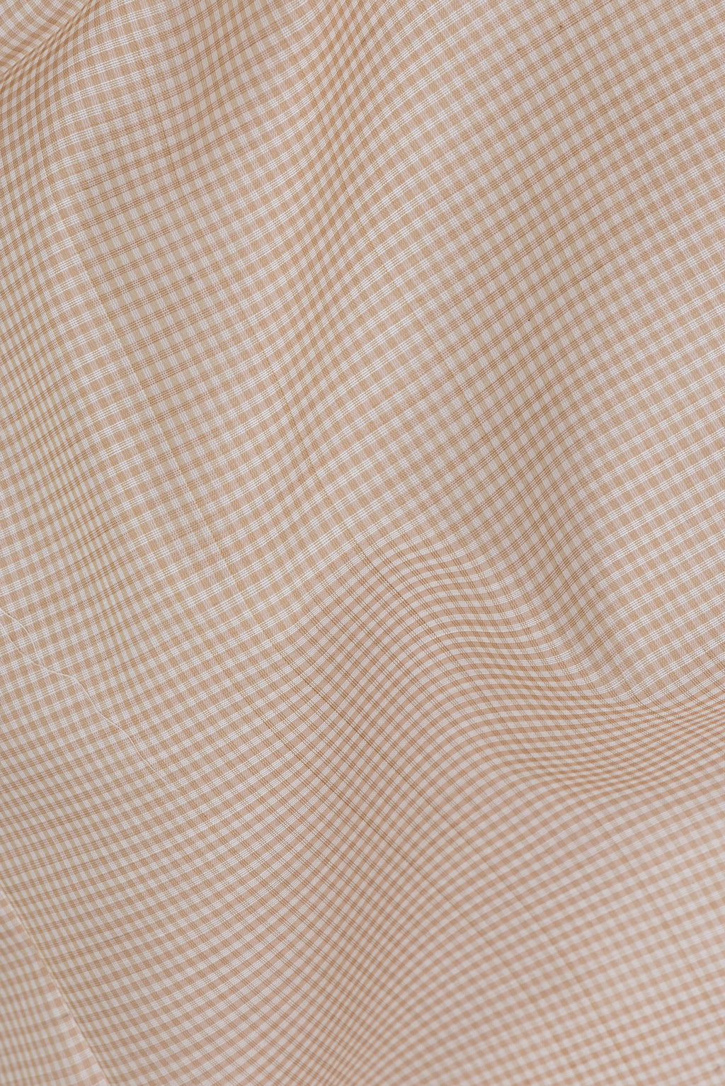 Close up of Beige Maheshwari Silk Saree with Checked design on the body and Zari Border.  displaying folds
