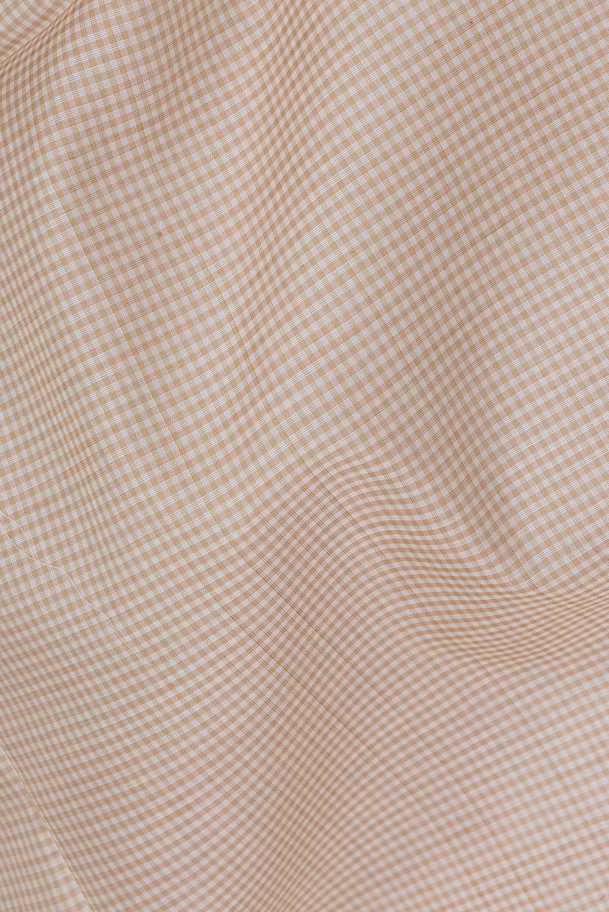 Close up of Beige Maheshwari Silk Saree with Checked design on the body and Zari Border.  displaying folds