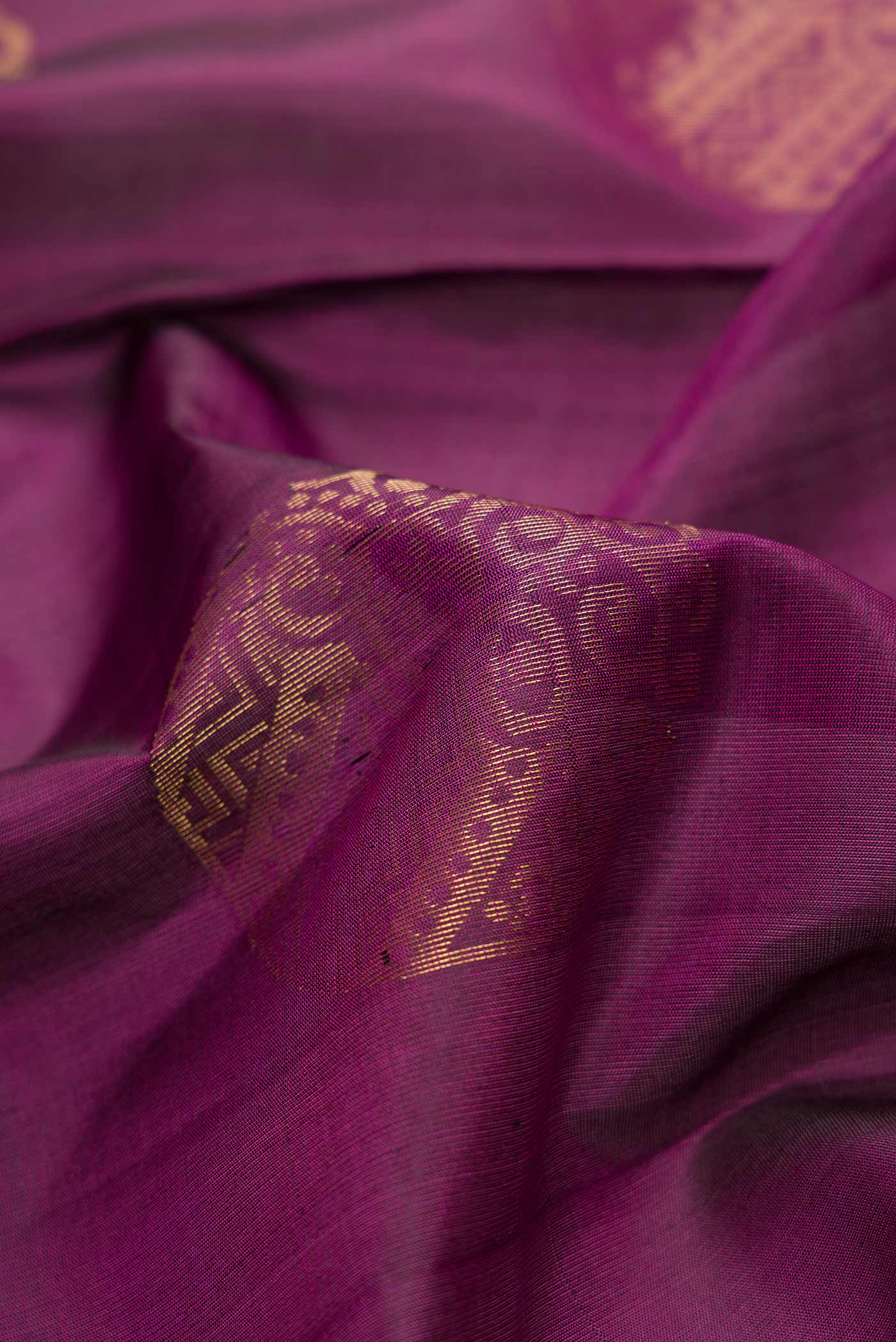 Close up of Purple Dual Tone Soft Silk Saree with Zari Butta on the body and Zari Border.  displaying folds