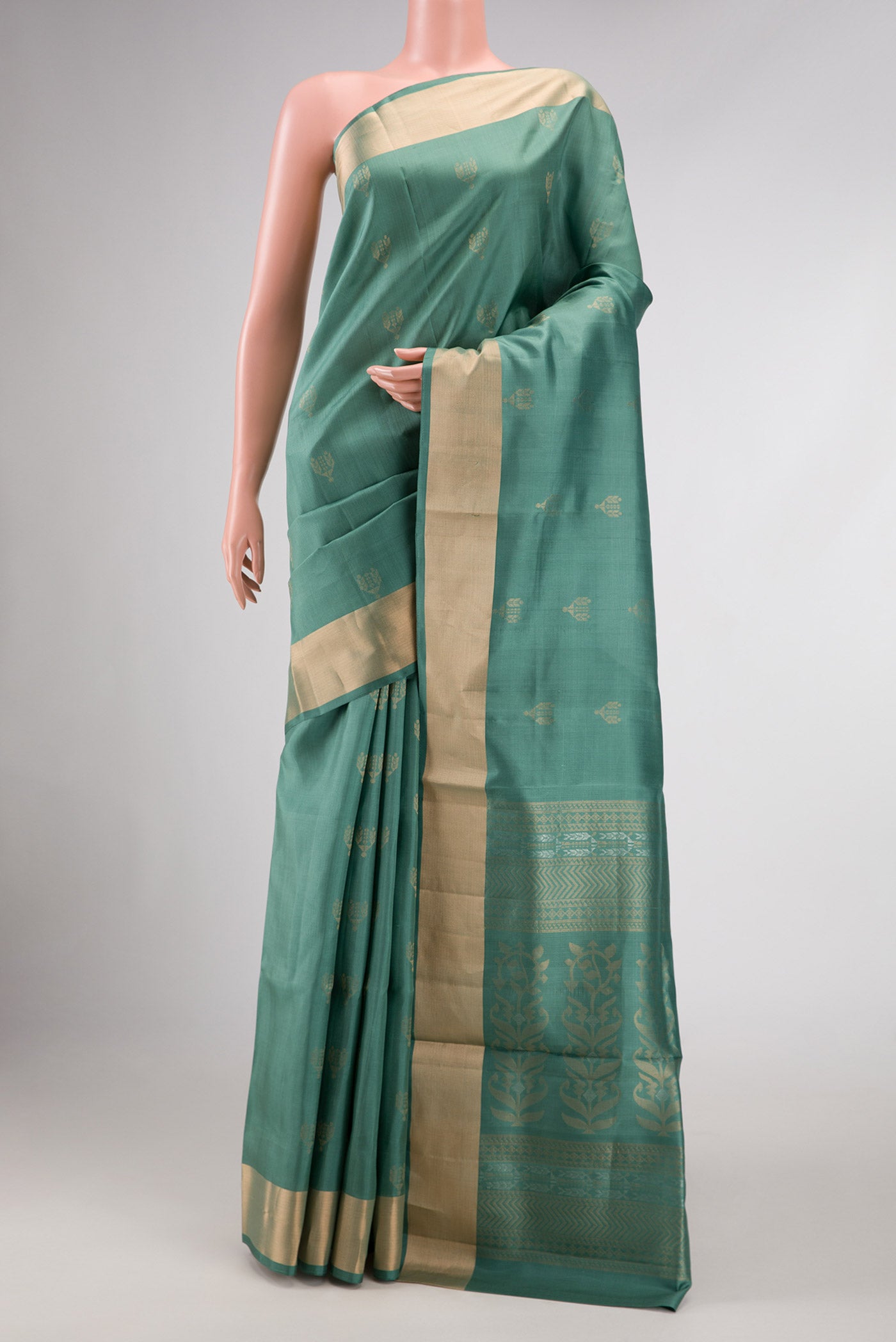 Green Dual Tone Soft Silk Saree with Zari Butta on the body and Zari Border displayed on a mannequin
