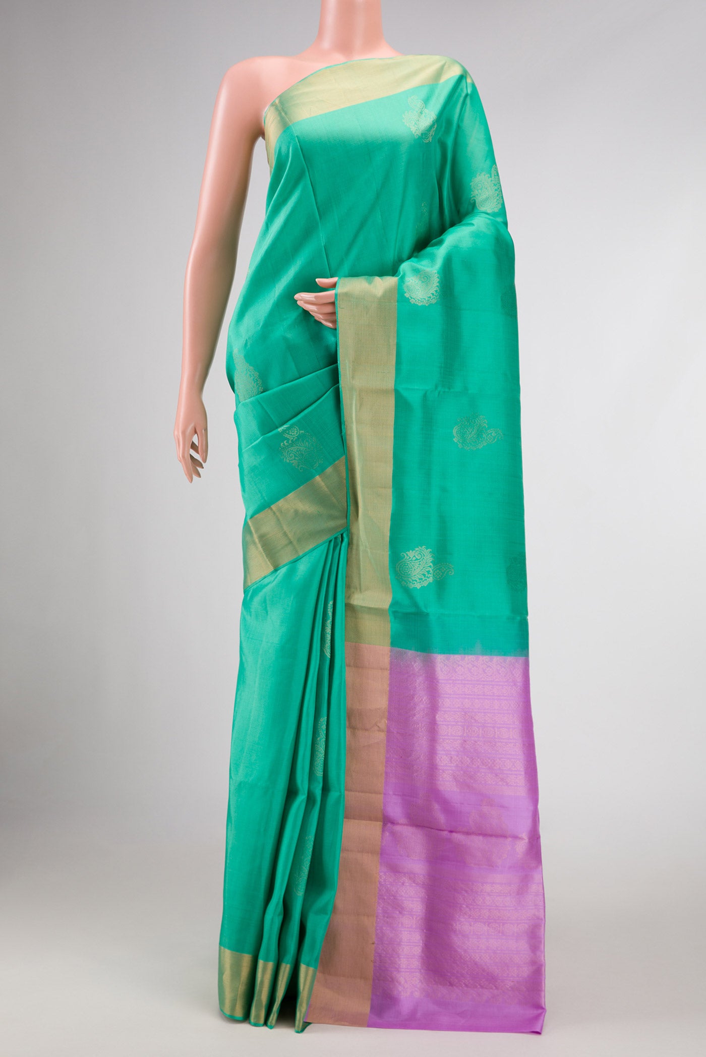 Sea Green Dual Tone Soft Silk Saree with Zari Butta on the body and Zari Border displayed on a mannequin
