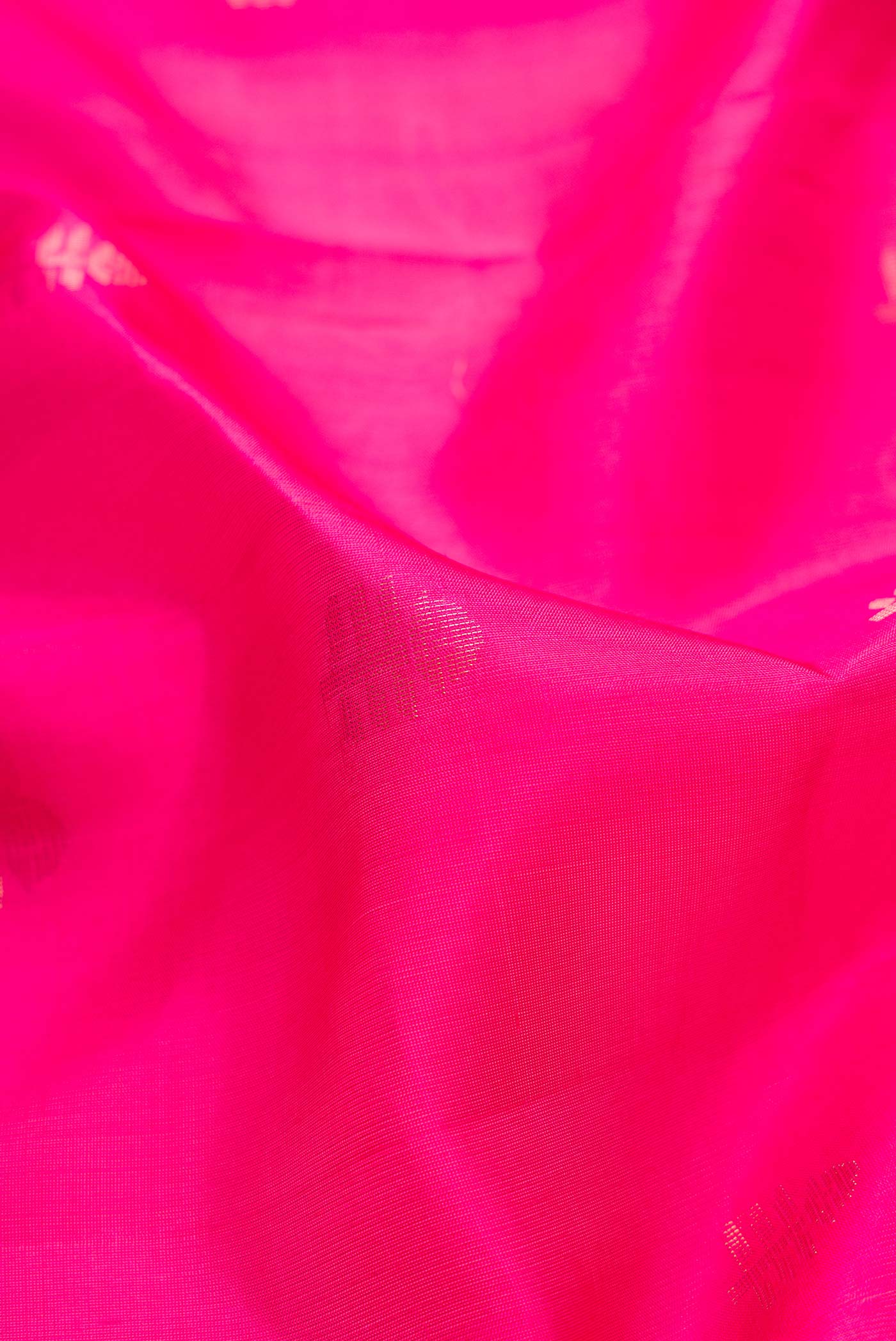 Close up of Dark Pink Dual Tone Soft Silk Saree with Zari Butta on the body and Zari Border.  displaying folds
