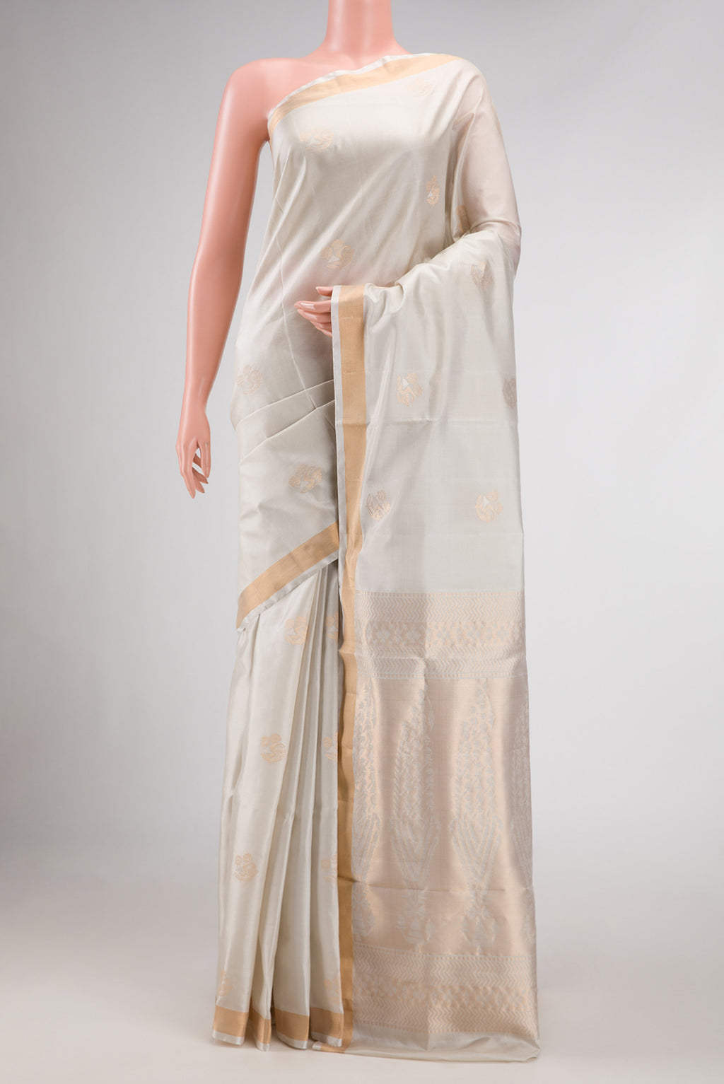 Off White Dual Tone Soft Silk Saree with Zari Butta on the body and Zari Border displayed on a mannequin