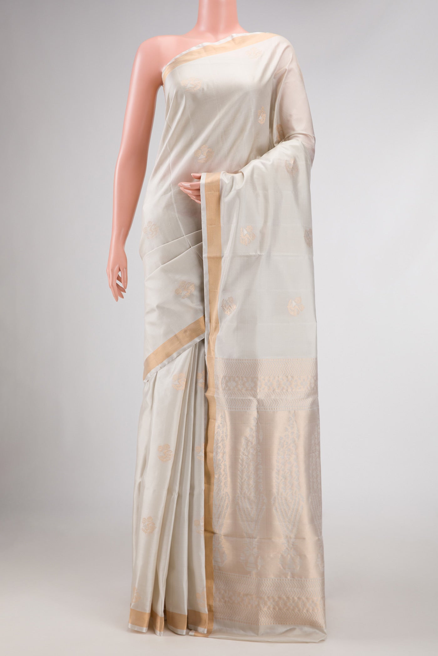 Off White Dual Tone Soft Silk Saree with Zari Butta on the body and Zari Border displayed on a mannequin