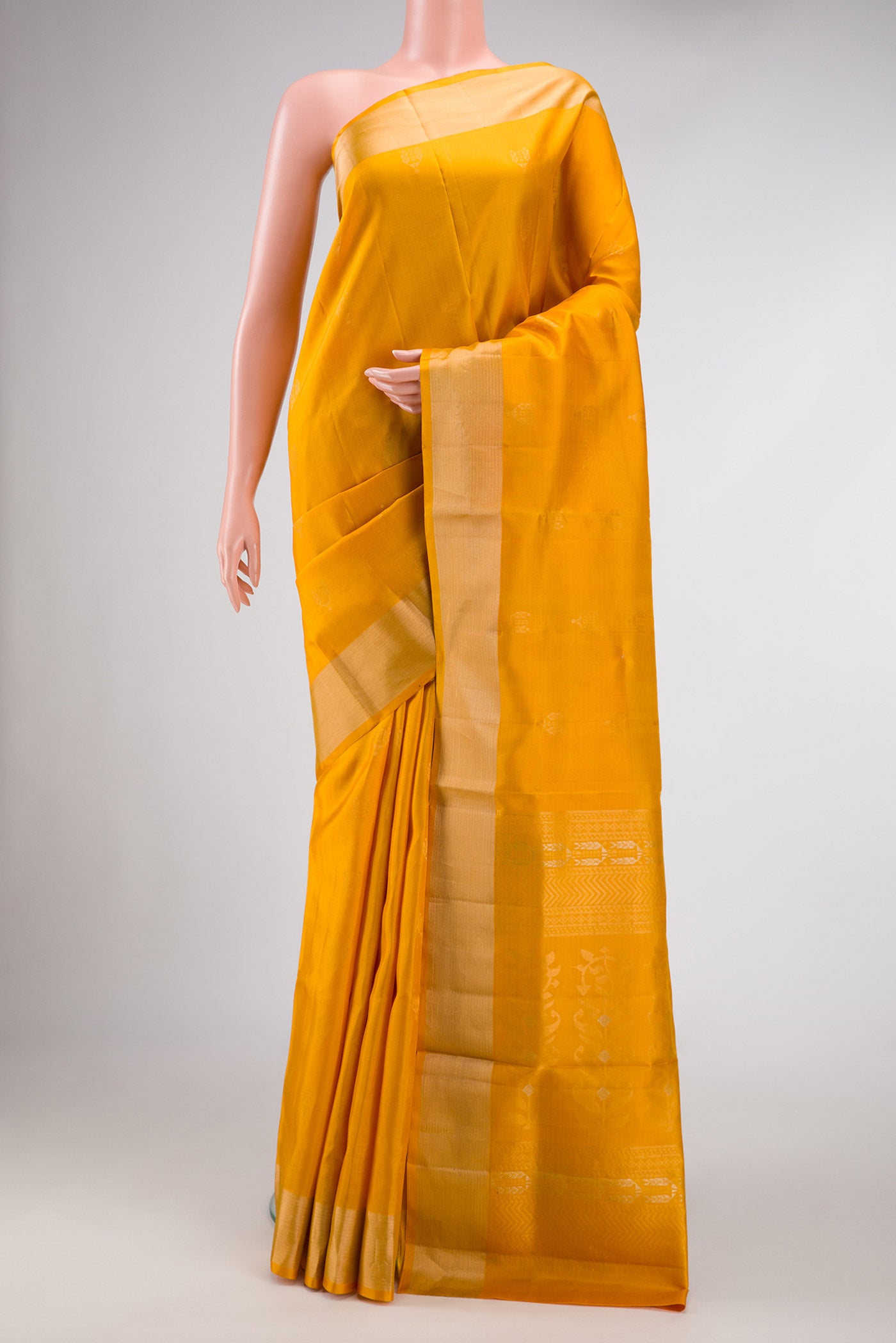 Mustard Dual Tone Soft Silk Saree with Zari Butta on the body and Zari Border.  displayed on a mannequin