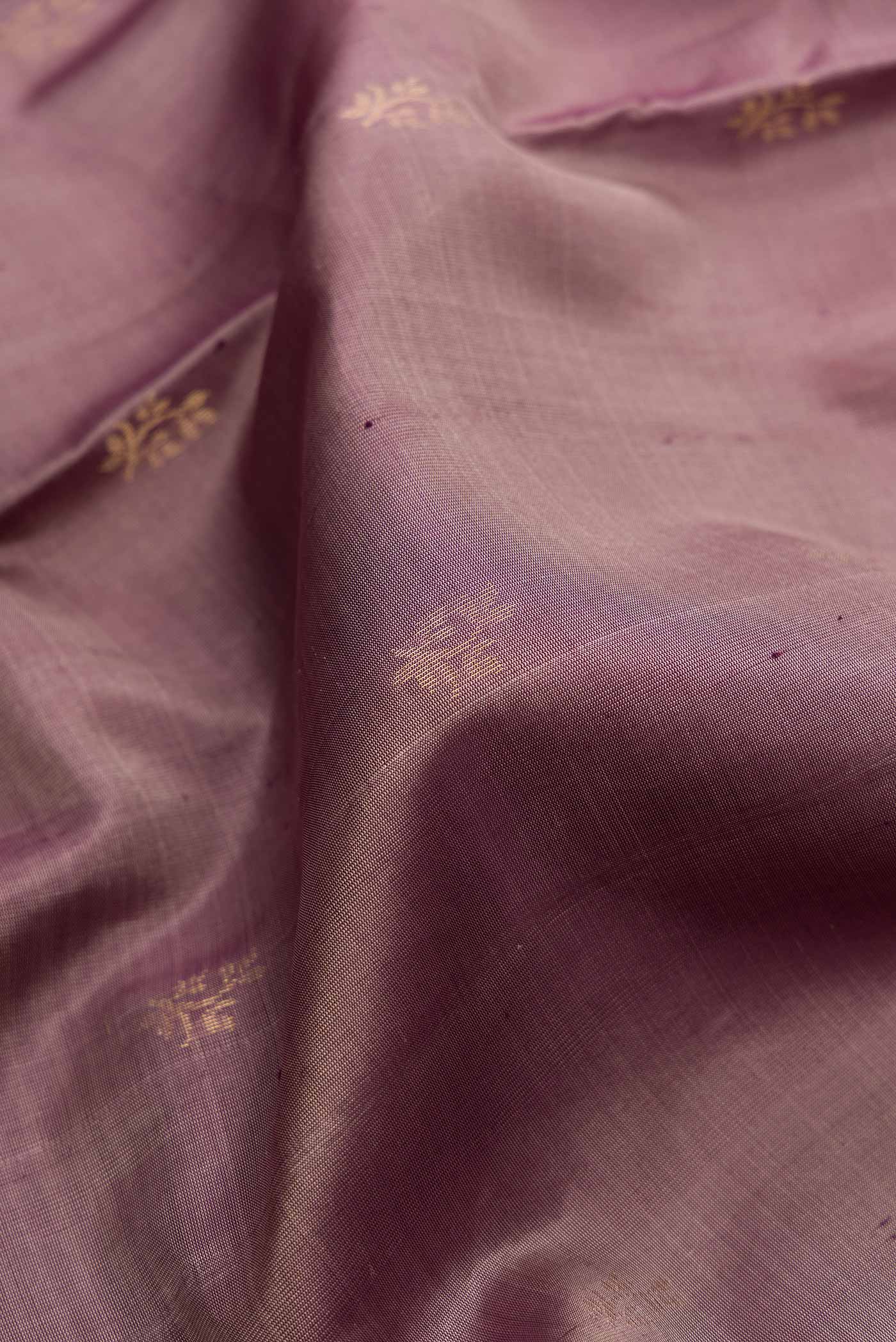 Close up of Purple Dual Tone Soft Silk Saree with Zari Butta on the body and Zari Border.  displaying folds