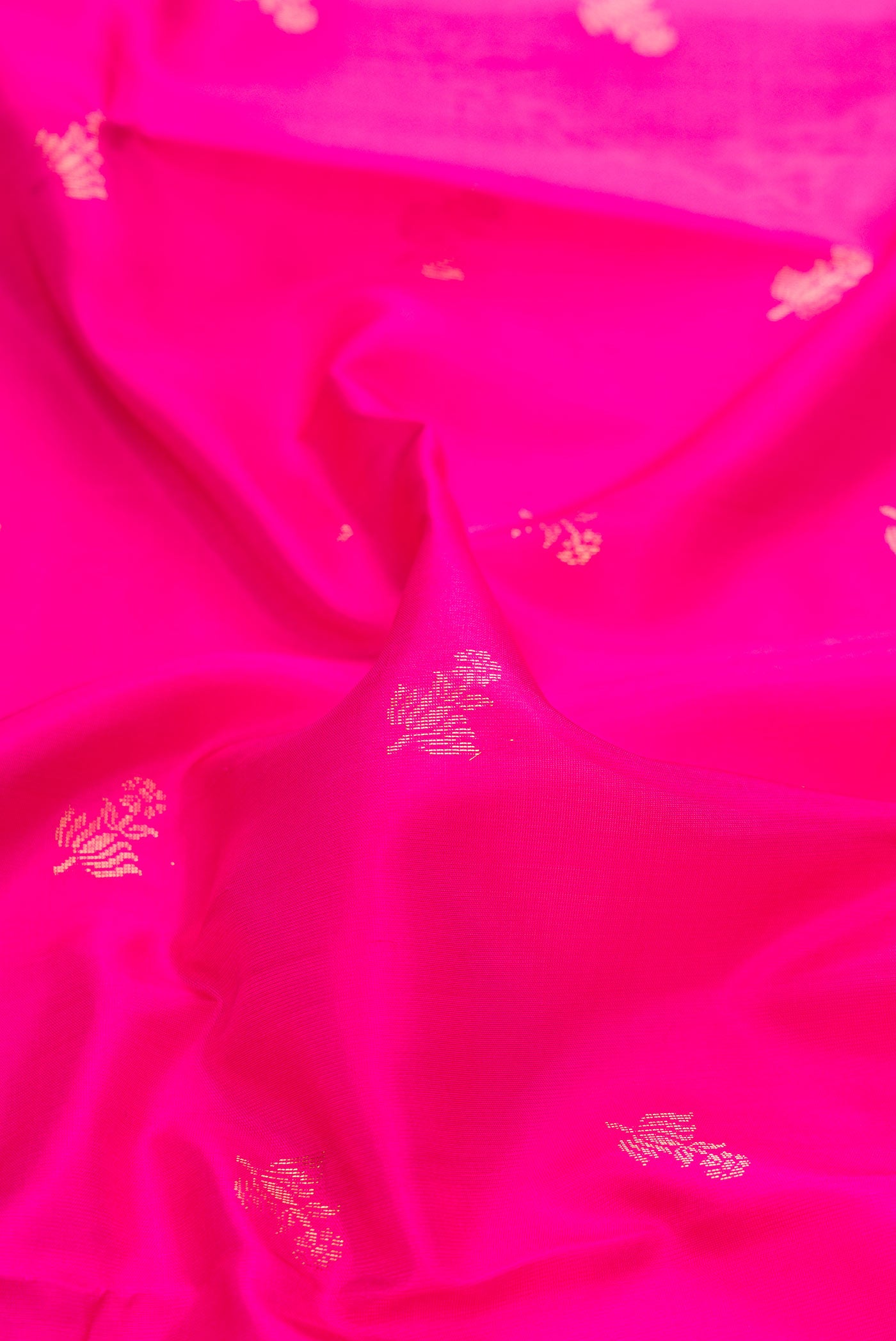 Close up of Pink Dual Tone Soft Silk Saree with Zari Butta on the body and Zari Border displaying folds