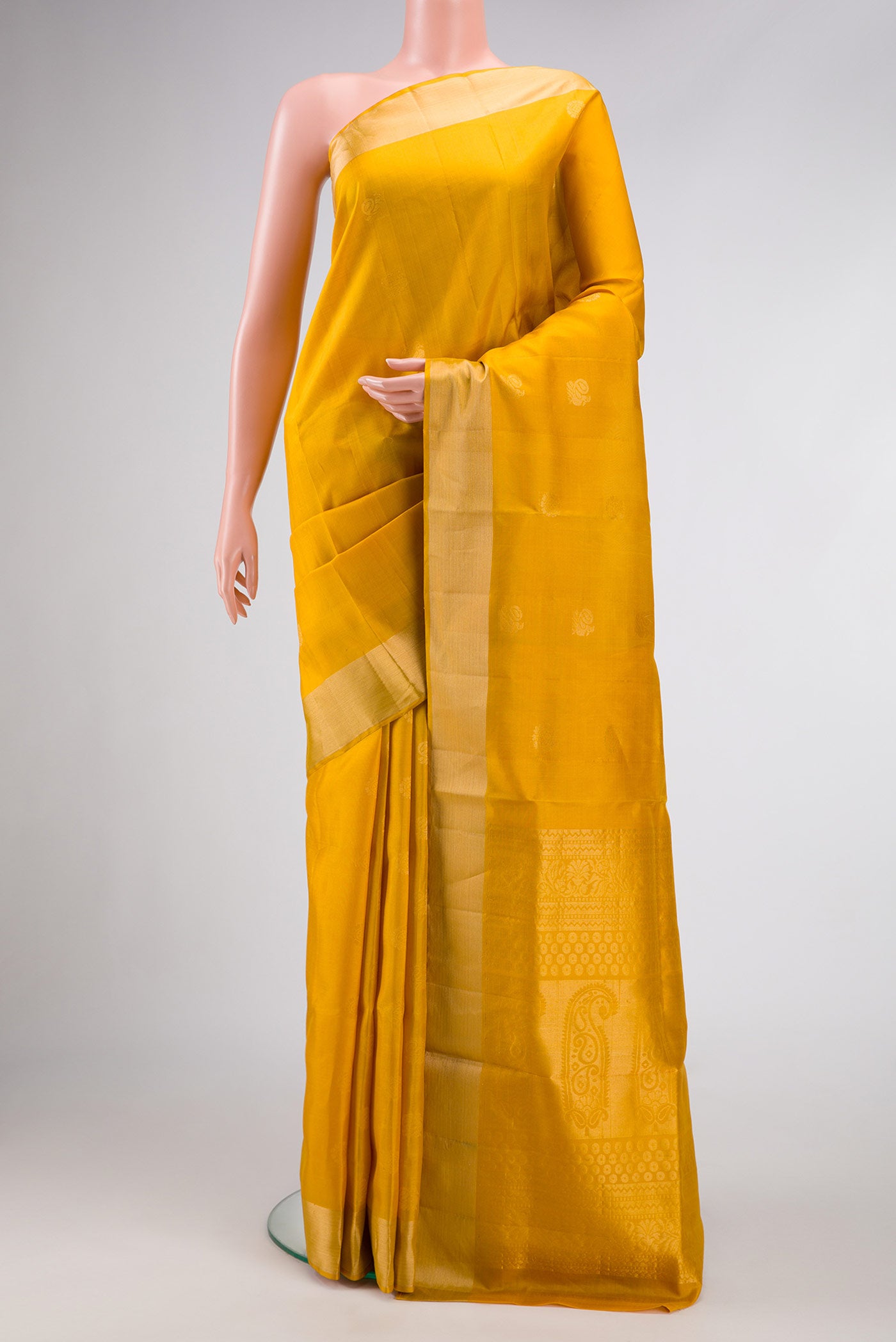 Mustard Dual Tone Soft Silk Saree with Zari Butta on the body and Zari Border.  displayed on a mannequin