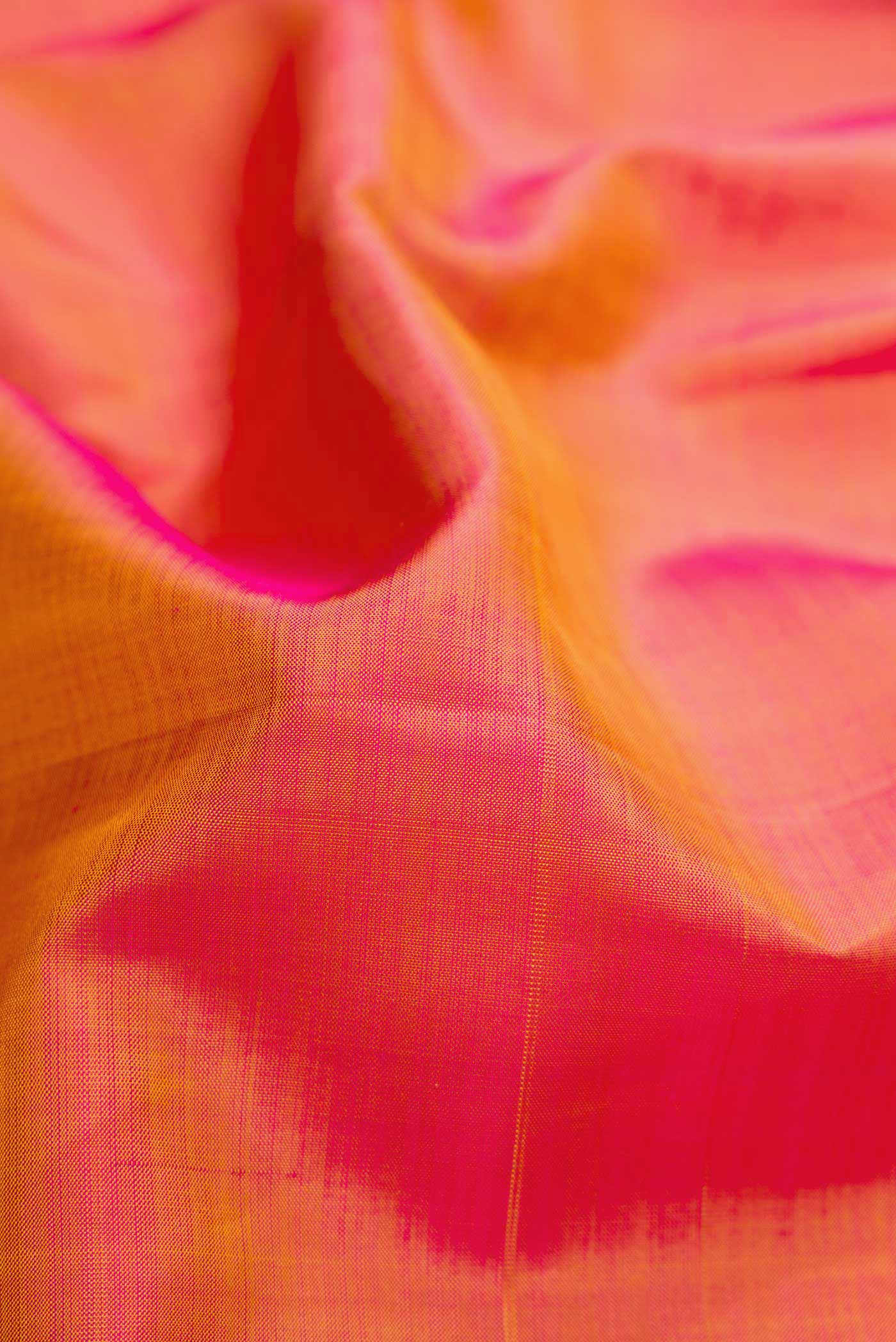 Close up of Mustard Dual Tone Kanjivaram Silk Saree with Plain Body and Zari Border.  displaying folds