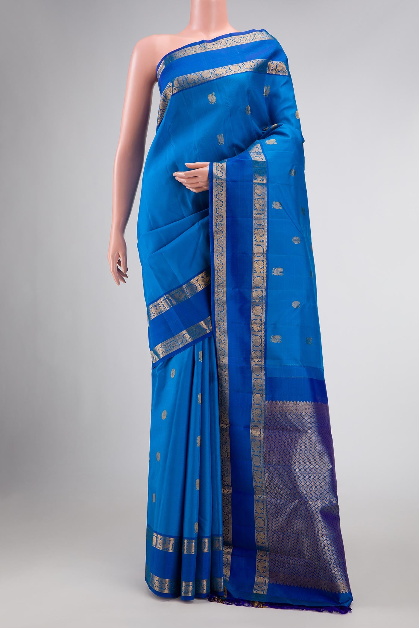 Royal Blue Kanchipuram Silk Saree with Zari Butta on the body and Zari Border displayed on a mannequin