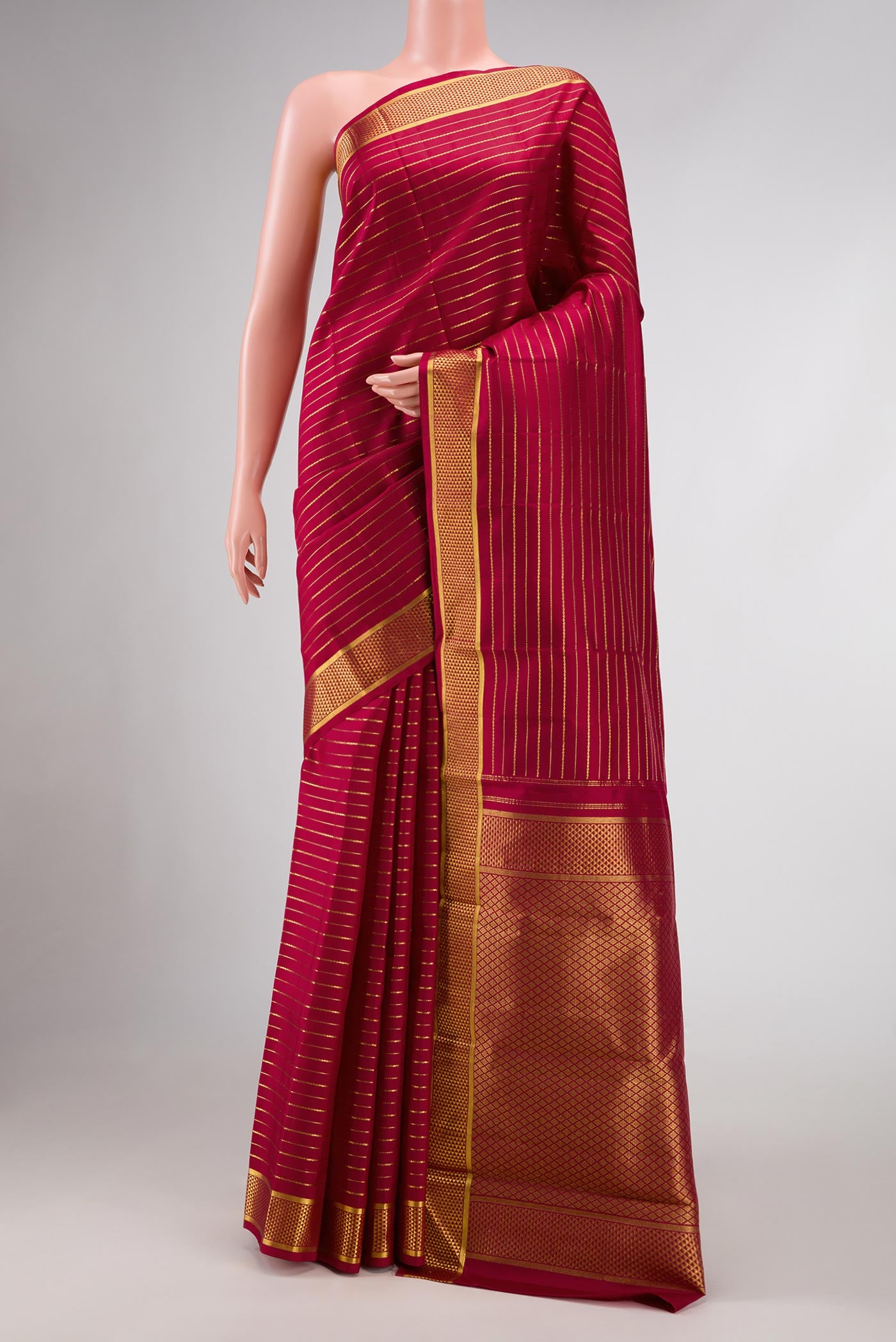 Maroon Dual Tone Kanchipuram Silk Saree with Checked design on the body and Zari Border.  displayed on a mannequin