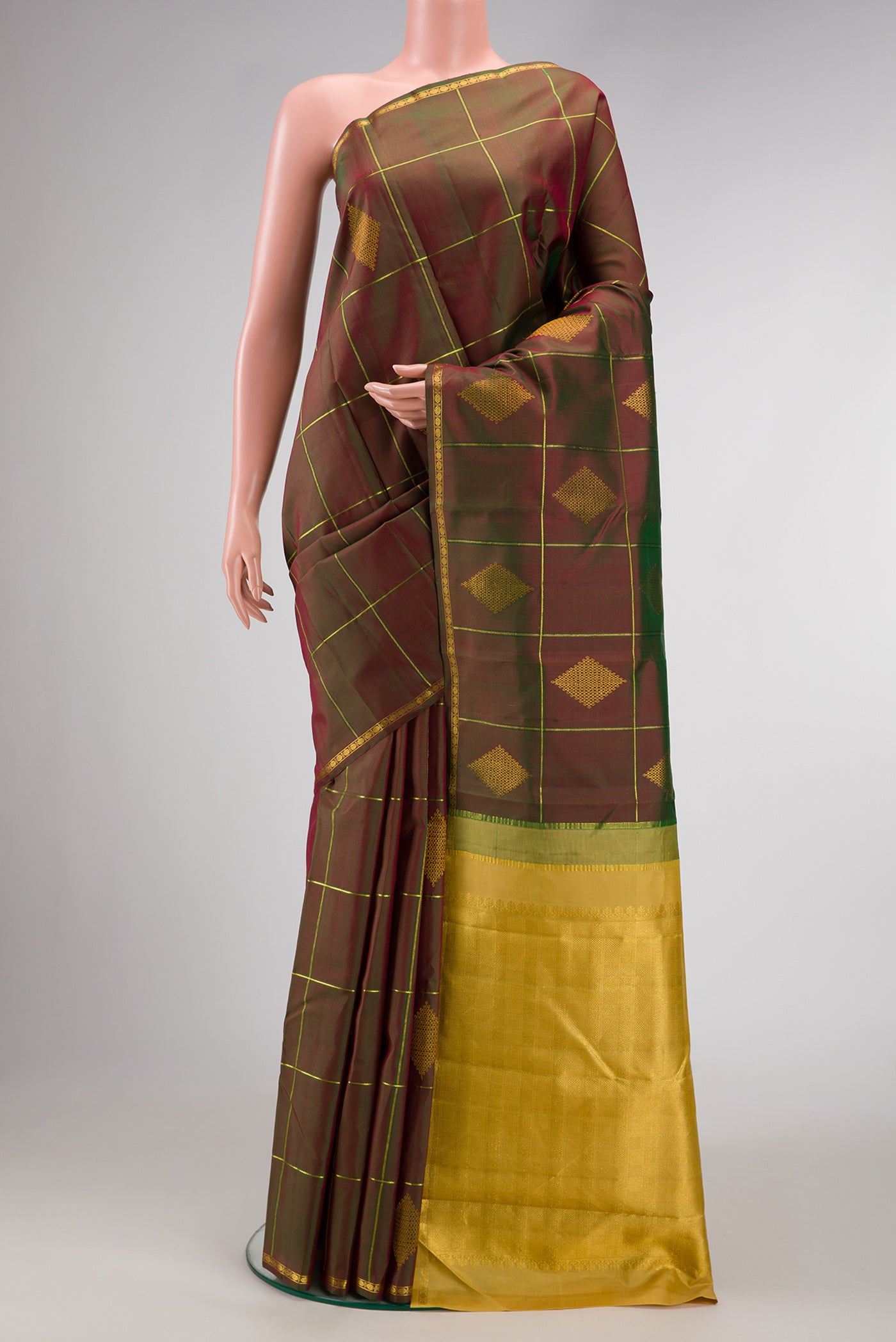 Mehandi Green Dual Tone Kanchipuram Silk Saree with Checked design on the body and Thin Zari Line.  displayed on a mannequin