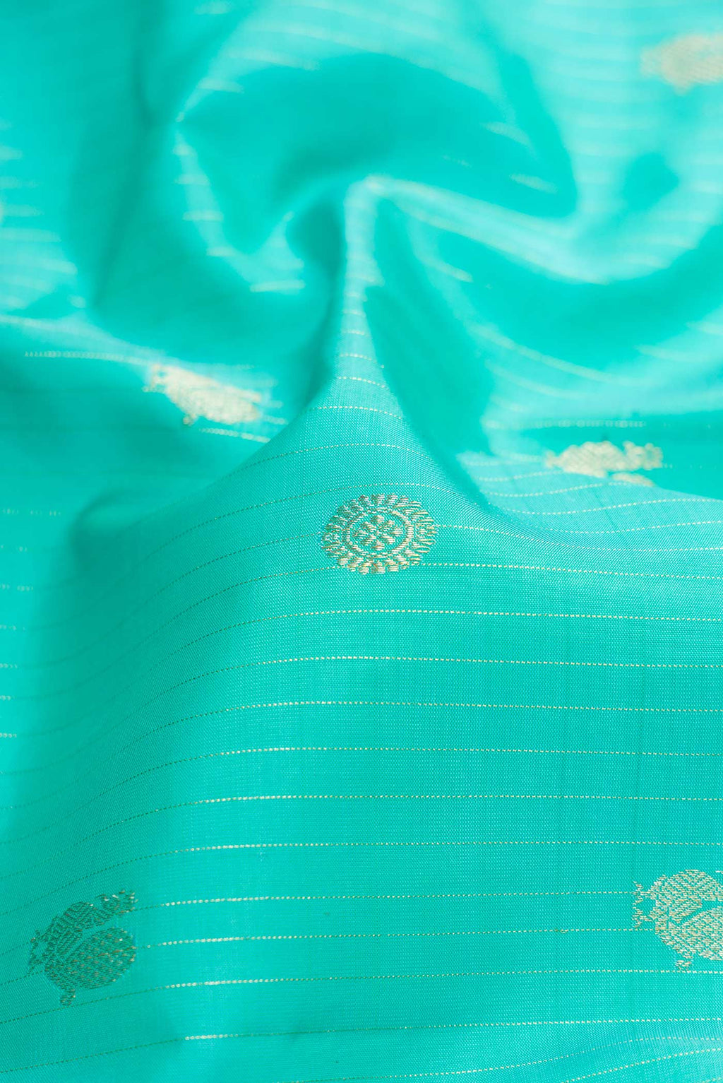 Close up of Sea Green Dual Tone Kanchipuram Silk Saree with Stripes on the body and Zari Border.  displaying folds