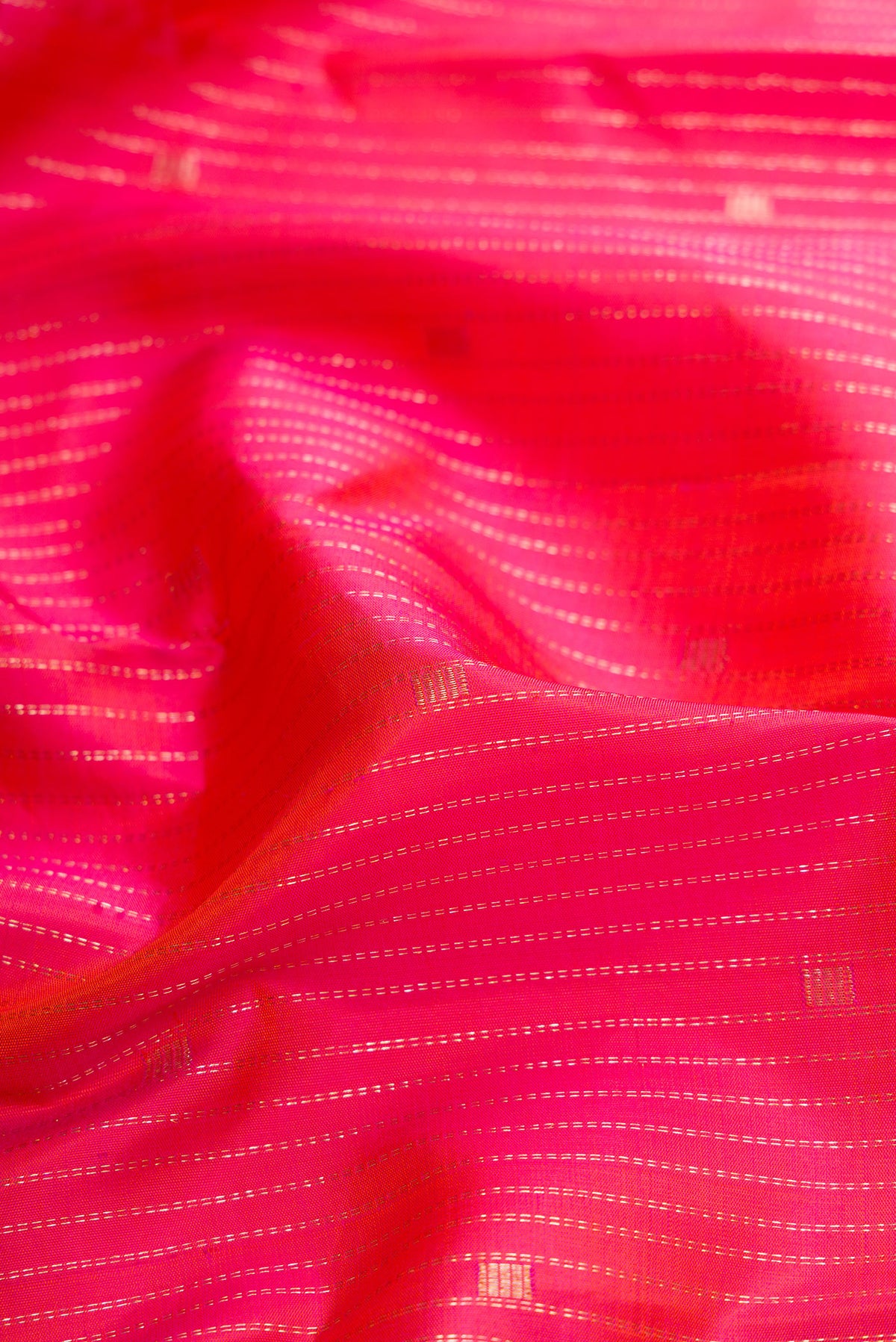 Close up of Pink Dual Tone Kanchipuram Silk Saree with Stripes on the body and Zari Border.  displaying folds