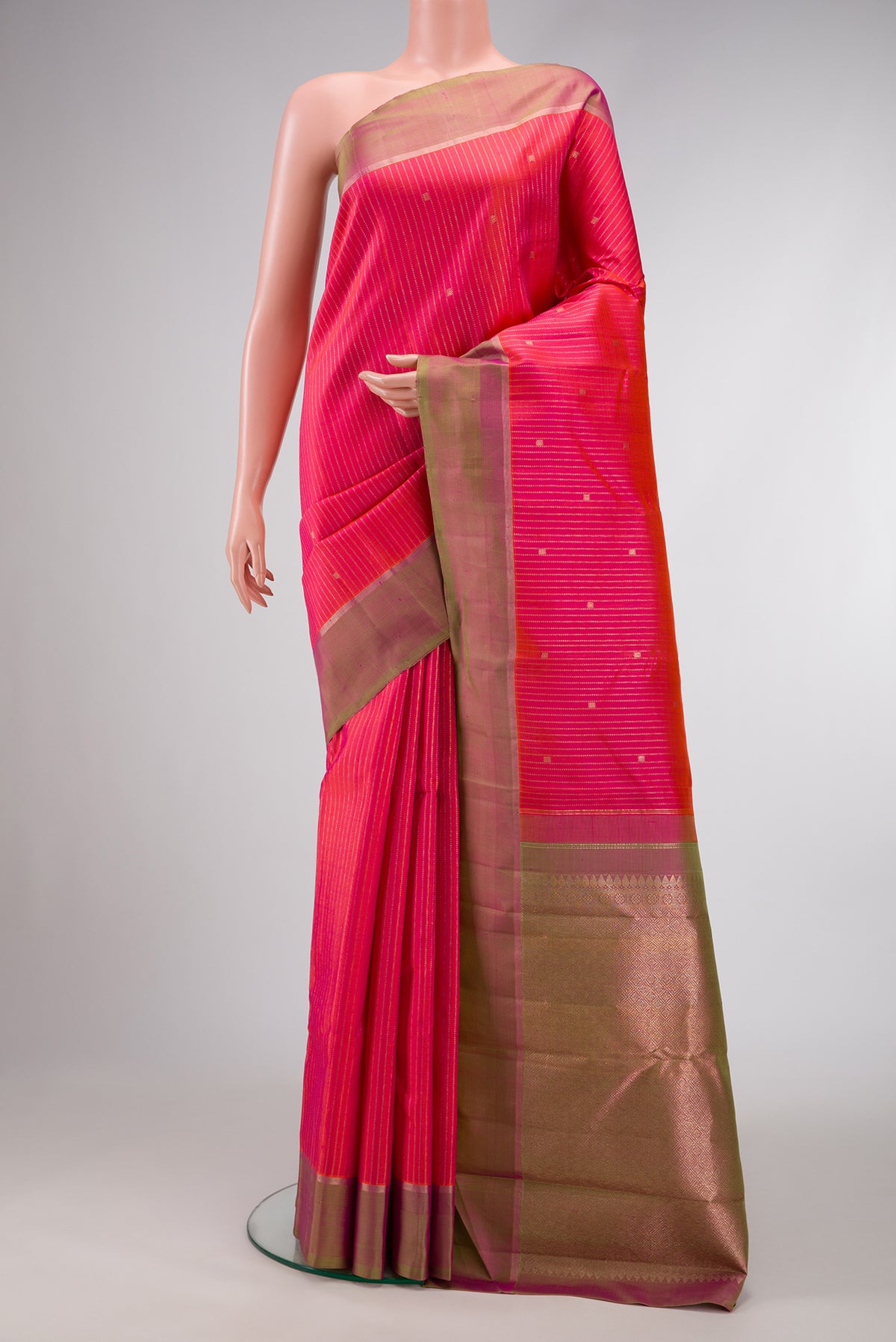 Pink Dual Tone Kanchipuram Silk Saree with Stripes on the body and Zari Border.  displayed on a mannequin