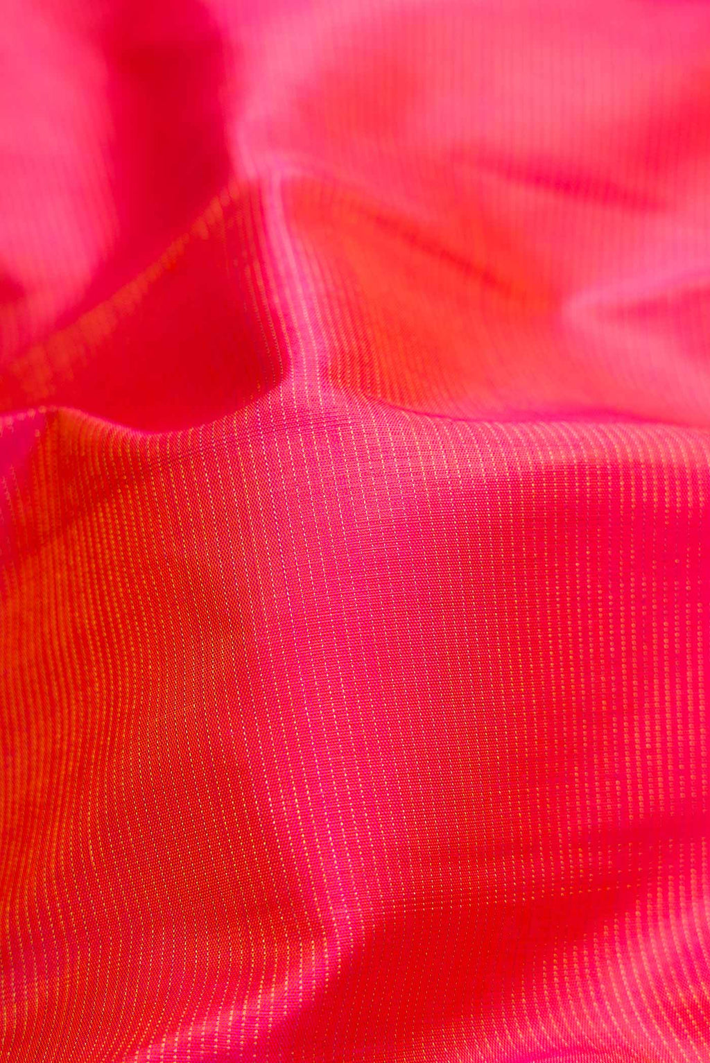 Close up of Brick Orange Dual Tone Kanchipuram Silk Saree with Stripes on the body and Zari Border.  displaying folds