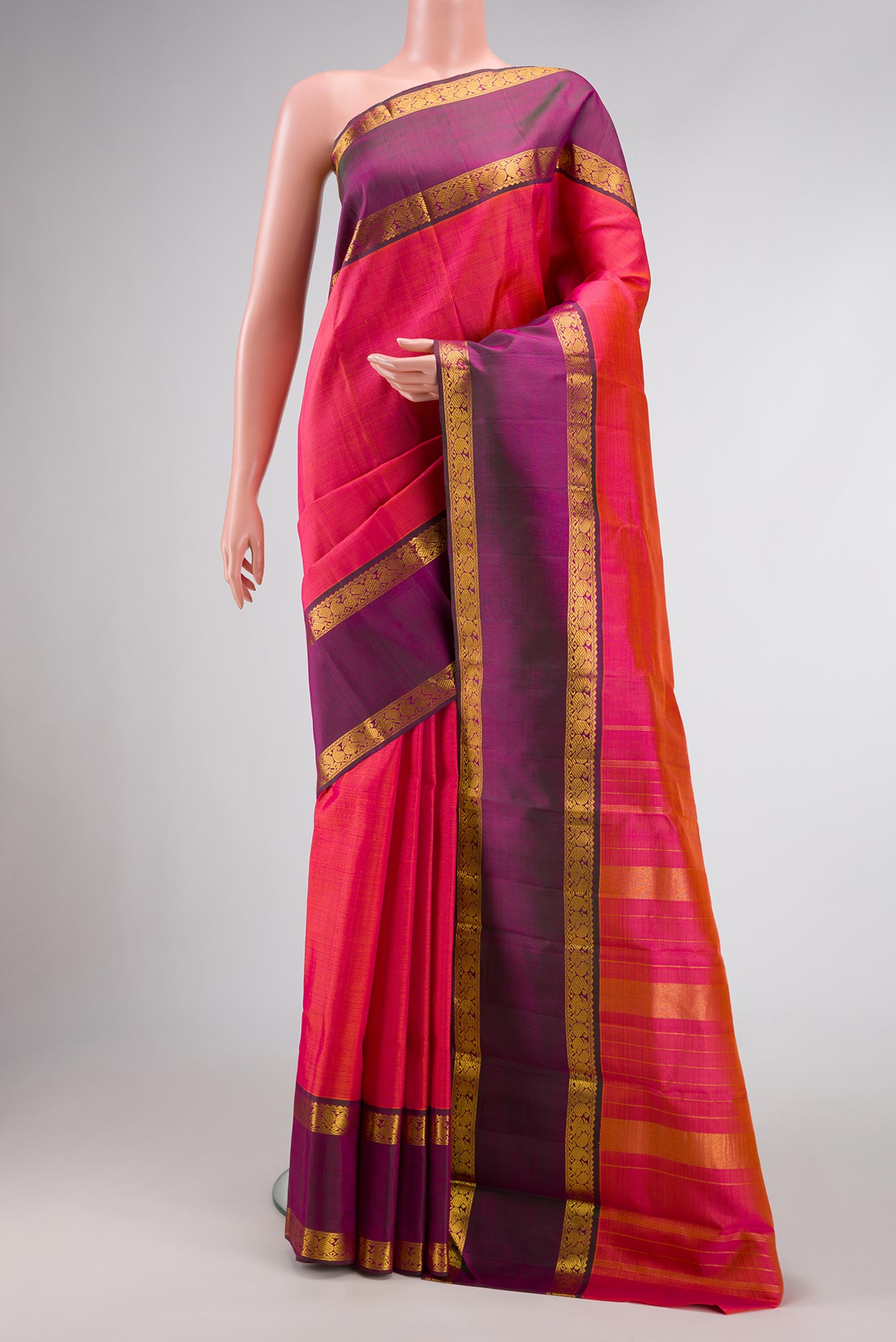 Brick Orange Dual Tone Kanchipuram Silk Saree with Stripes on the body and Zari Border.  displayed on a mannequin