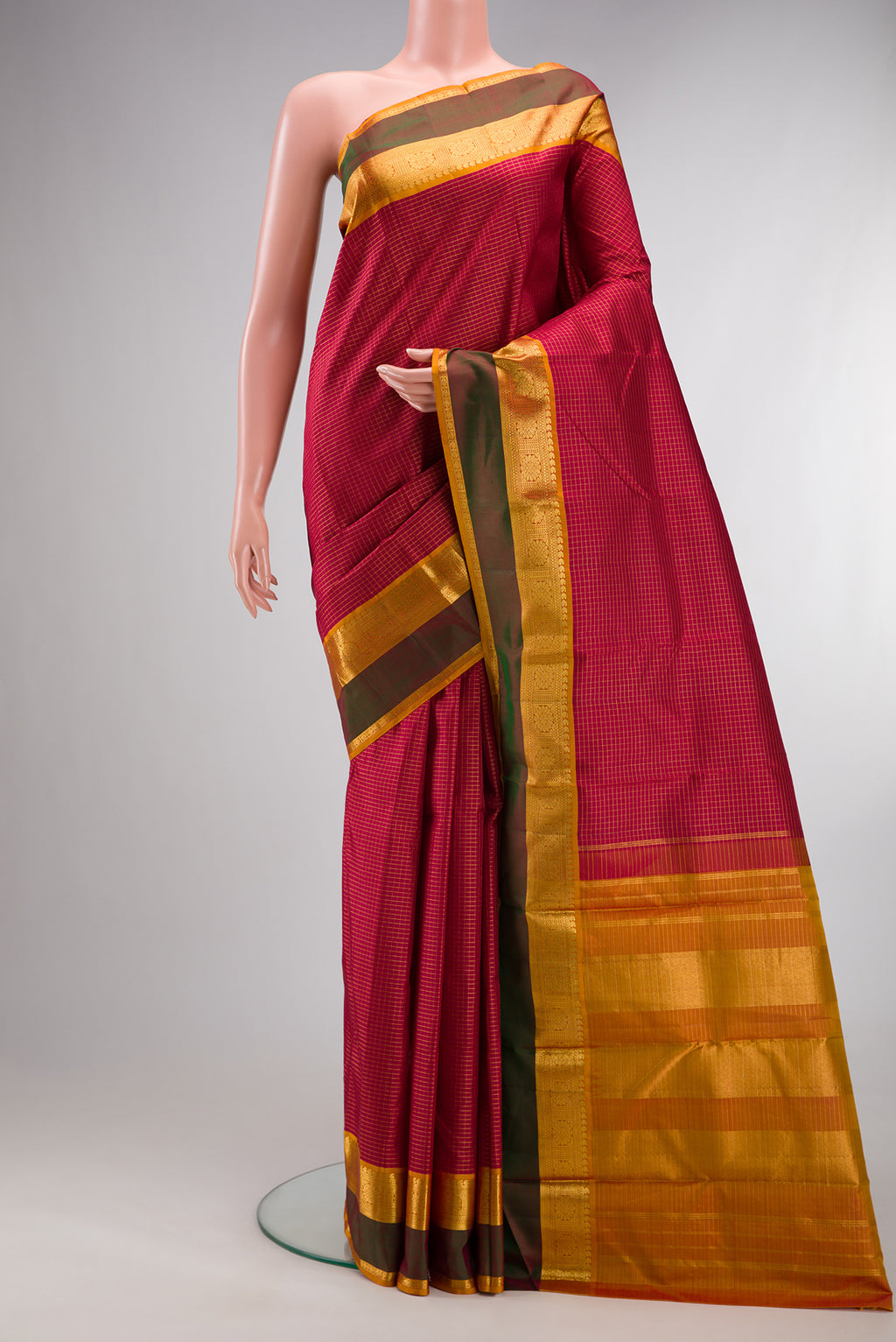 Pure Silk Maroon Kanchipuram Saree with Checked design on the body and Zari Border.  displayed on a mannequin