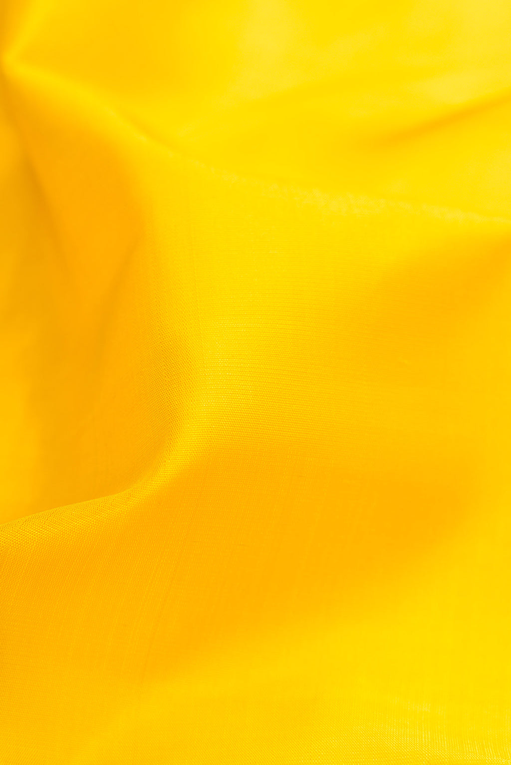 Close up of Yellow Dual Tone Kanjivaram Silk Saree with Plain Body and Zari Border.  displaying folds