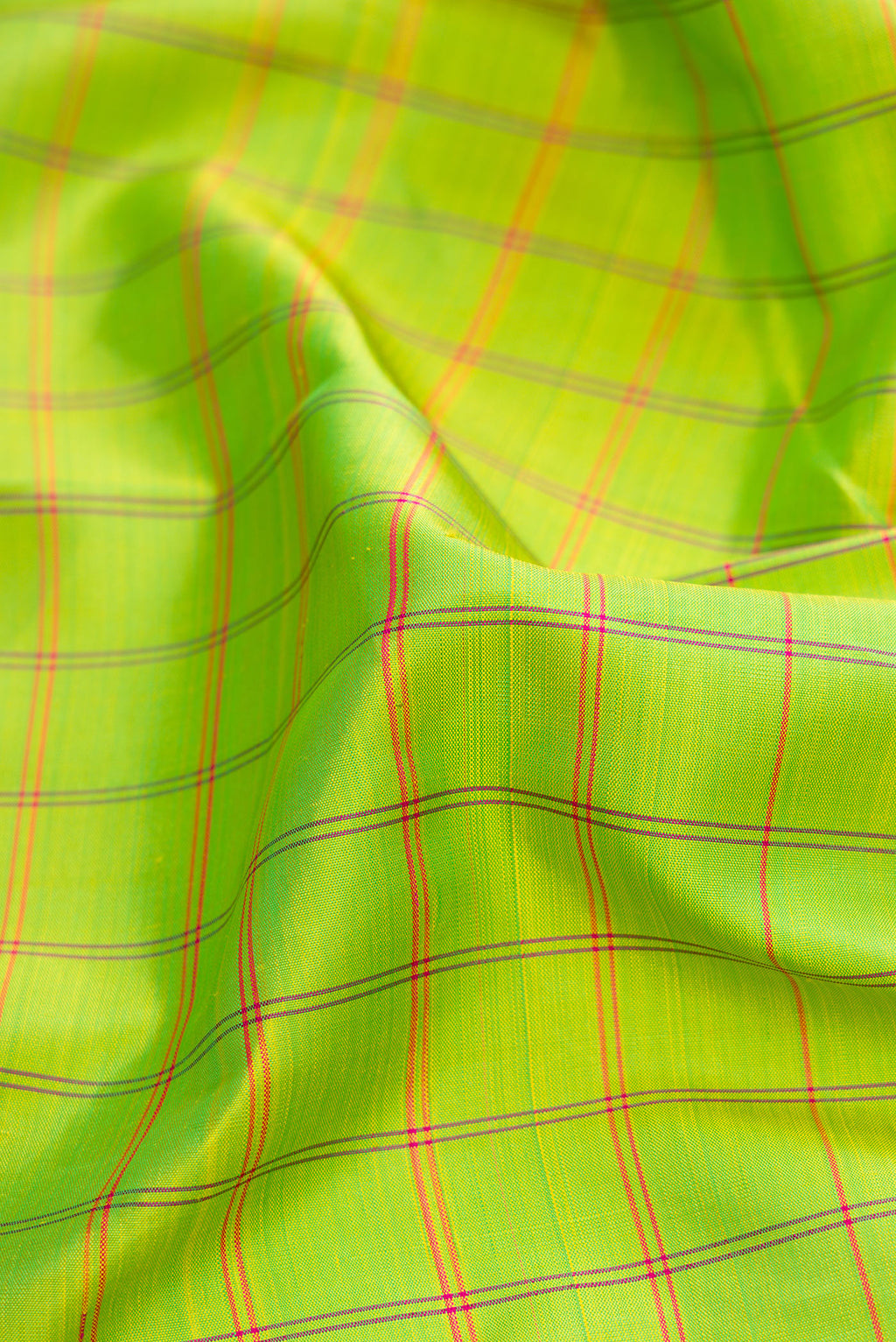 Close up of Parrot Green Dual Tone Kanchipuram Silk Saree with Checked design on the body and Zari And Thread Border.  displaying folds