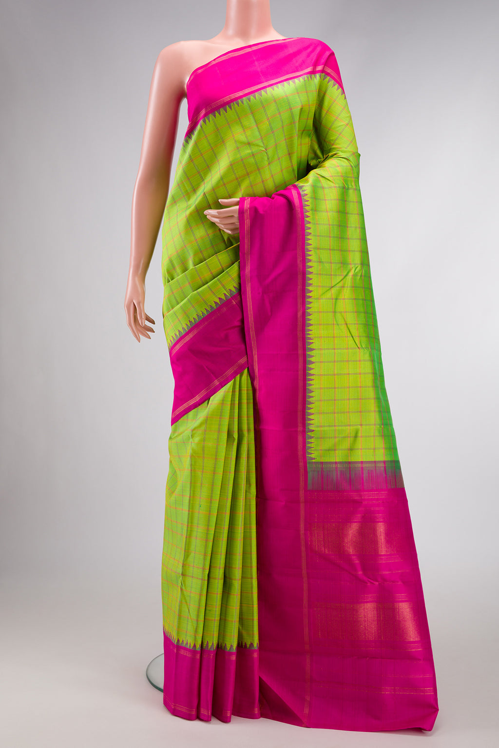 Parrot Green Dual Tone Kanchipuram Silk Saree with Checked design on the body and Zari And Thread Border.  displayed on a mannequin