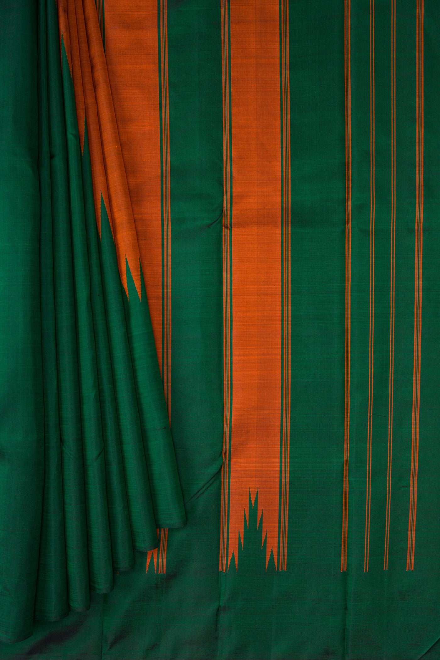 Pleats and pallu of Brick Orange Dual Tone Kanchipuram Silk Saree with Plain Body and Rising Temple Border. 