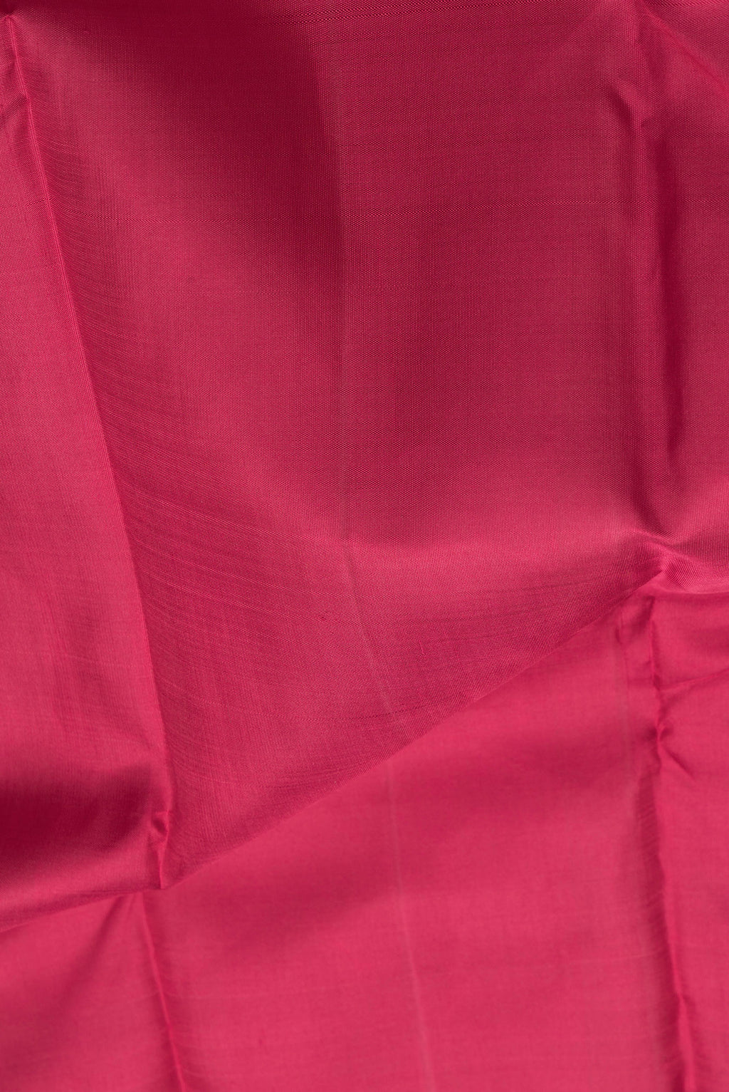 Close up of Maroon Dual Tone Kanchipuram Silk Saree with Plain Body and Zari Border.  displaying folds