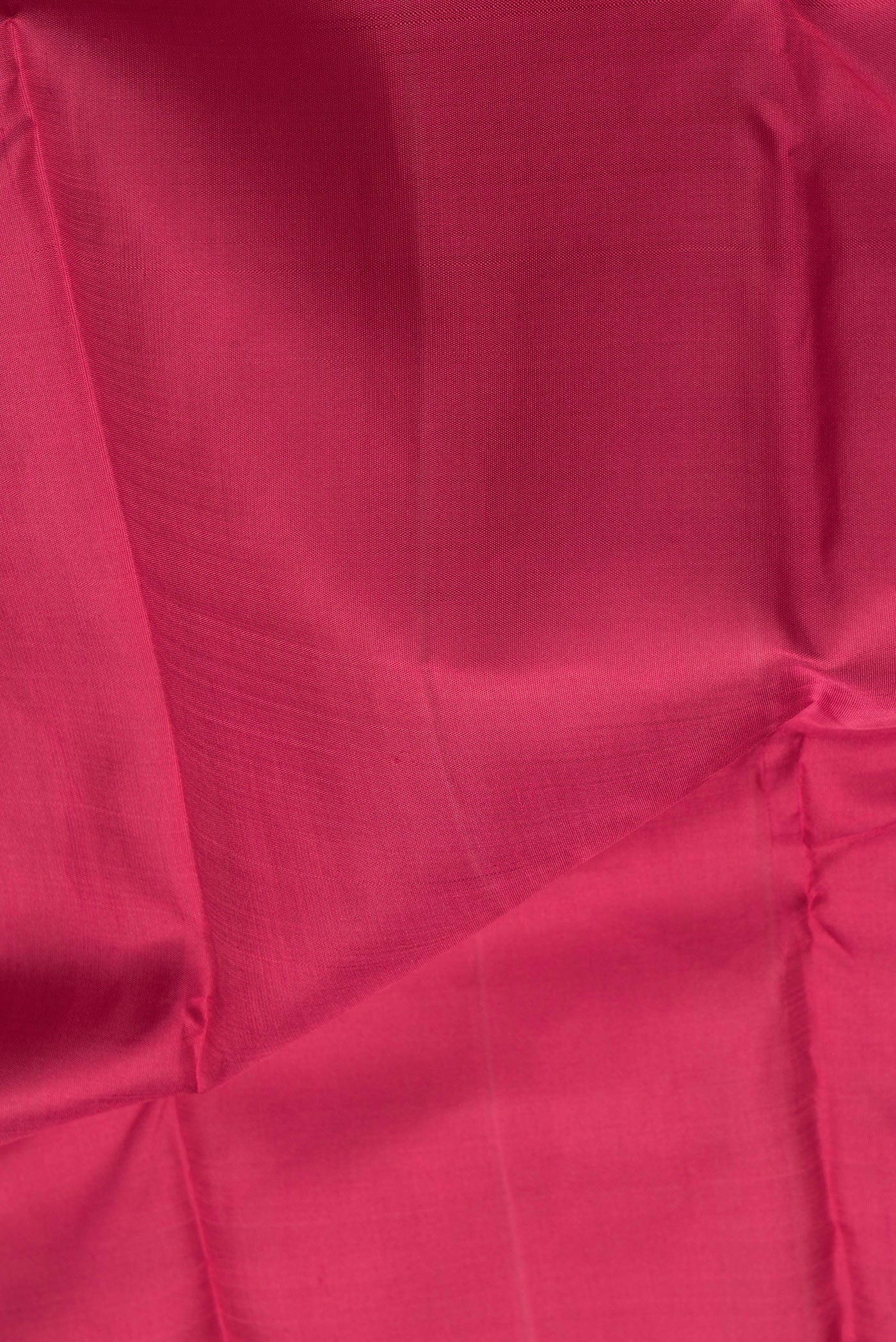 Close up of Maroon Dual Tone Kanchipuram Silk Saree with Plain Body and Zari Border.  displaying folds