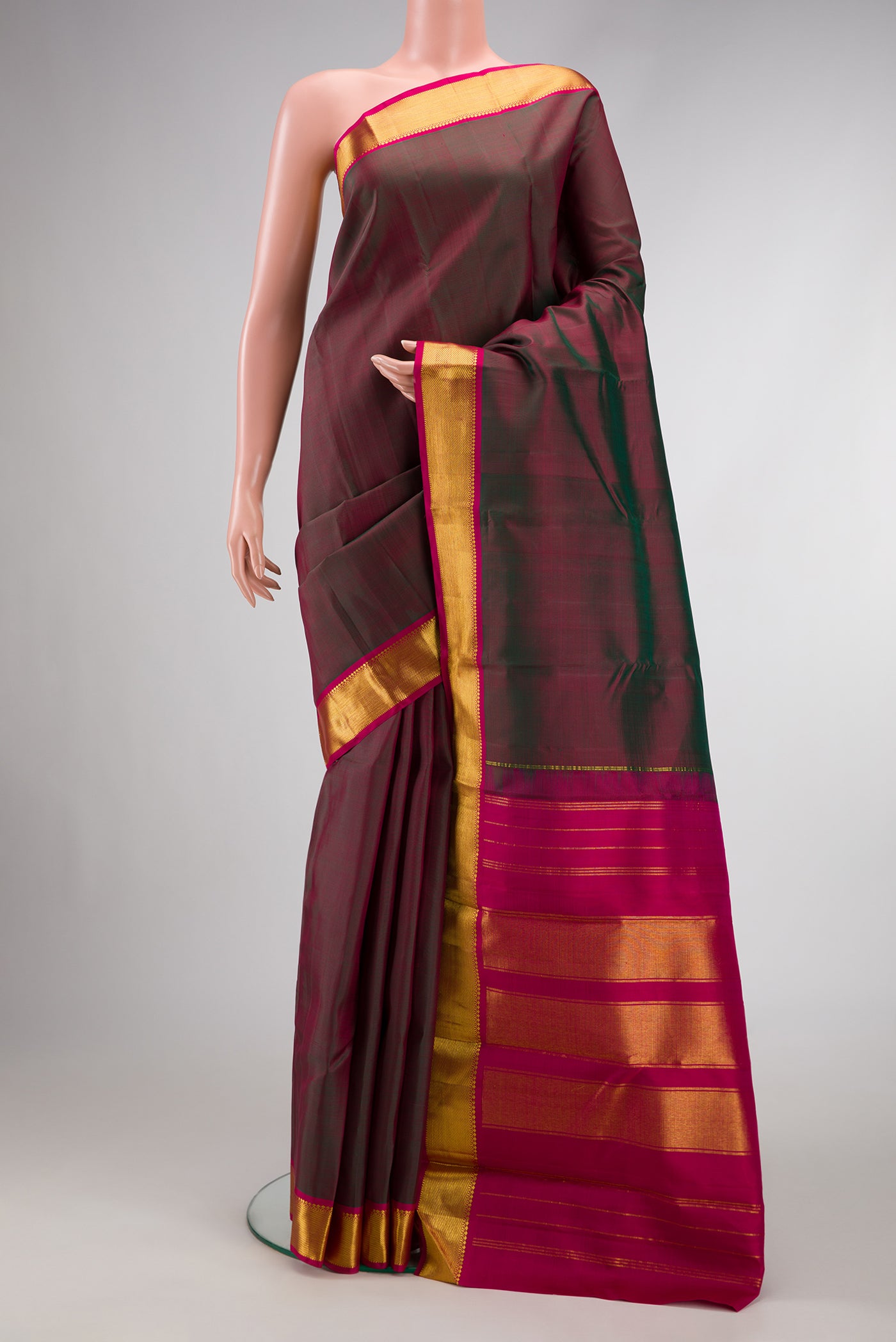 Green Dual Tone Kanchipuram Silk Saree with Plain Body and Zari Border.  displayed on a mannequin