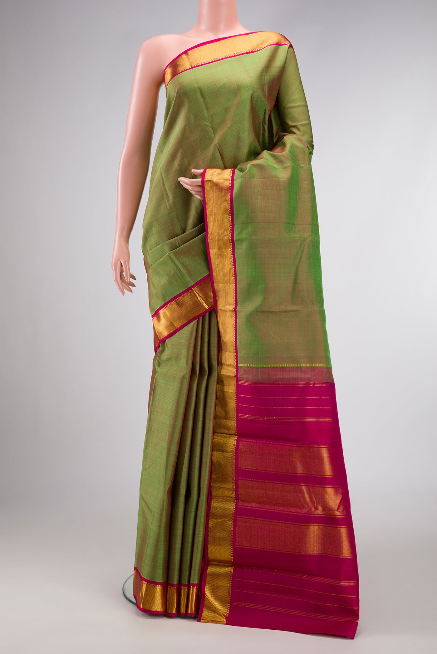 Green Dual Tone Kanchipuram Silk Saree with Plain Body and Zari Border.  displayed on a mannequin