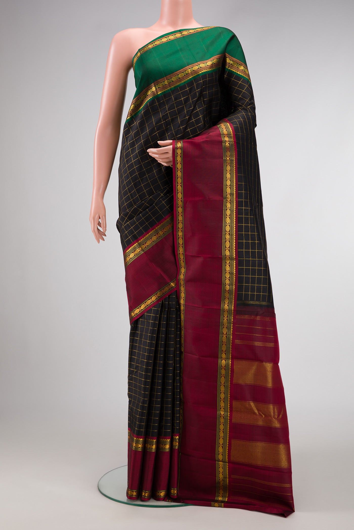 Black Dual Tone Kanchipuram Silk Saree with Checked design on the body and Ganga Jamuna Border.  displayed on a mannequin