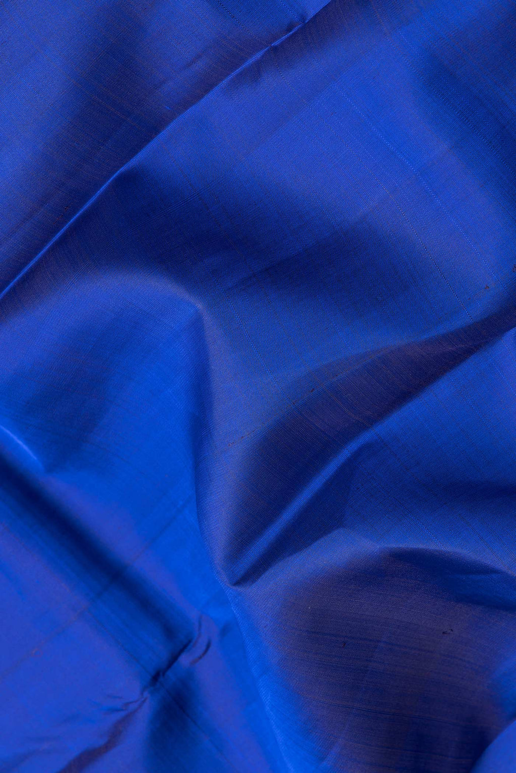 Close up of Royal Blue Dual Tone Kanchipuram Silk Saree with Plain Body and Zari Border.  displaying folds