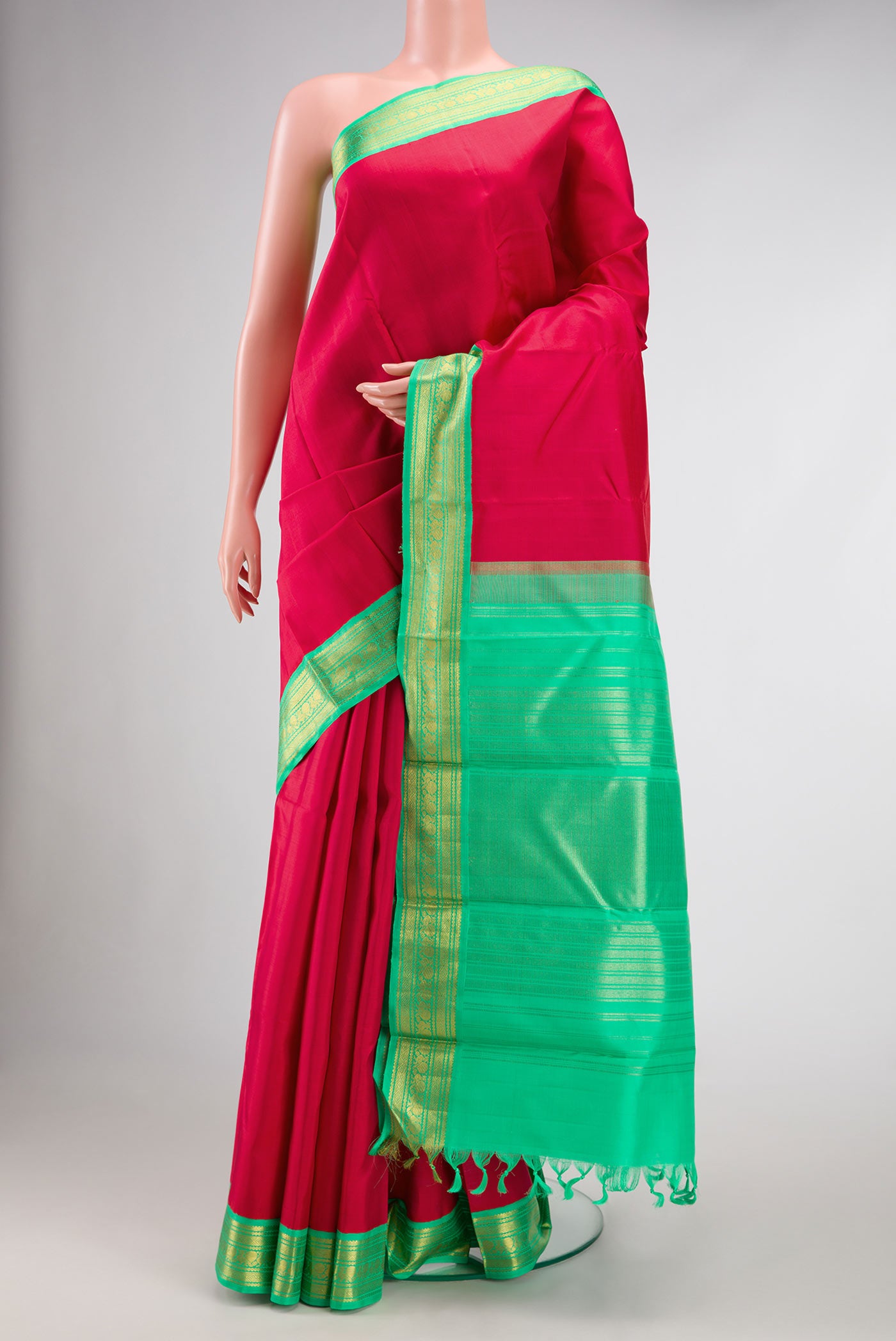 Red Dual Tone Kanjivaram Silk Saree with Plain Body and Zari Border.  displayed on a mannequin