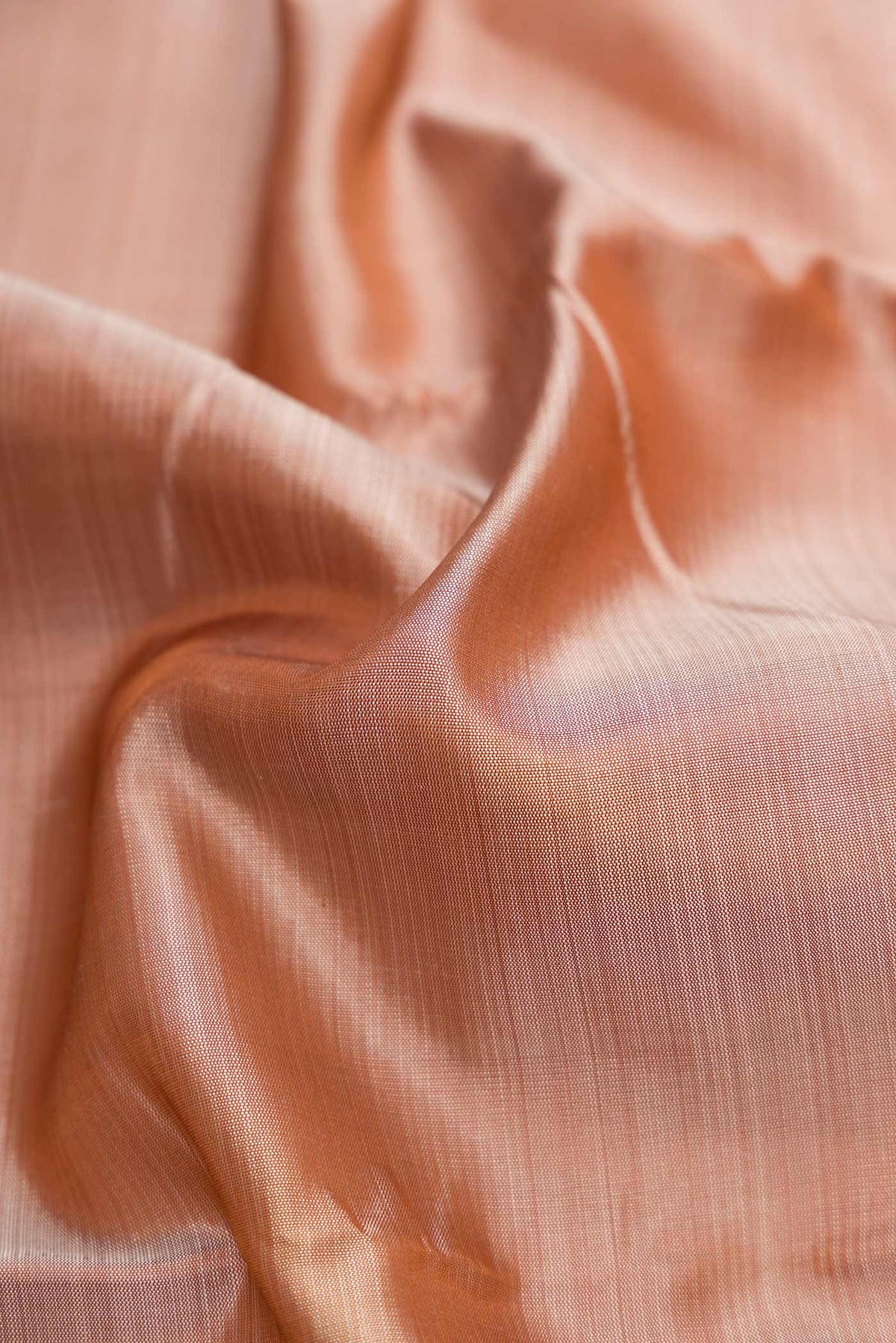 Close up of Dark Beige Dual Tone Kanjivaram Silk Saree with Plain Body and Zari Border.  displaying folds