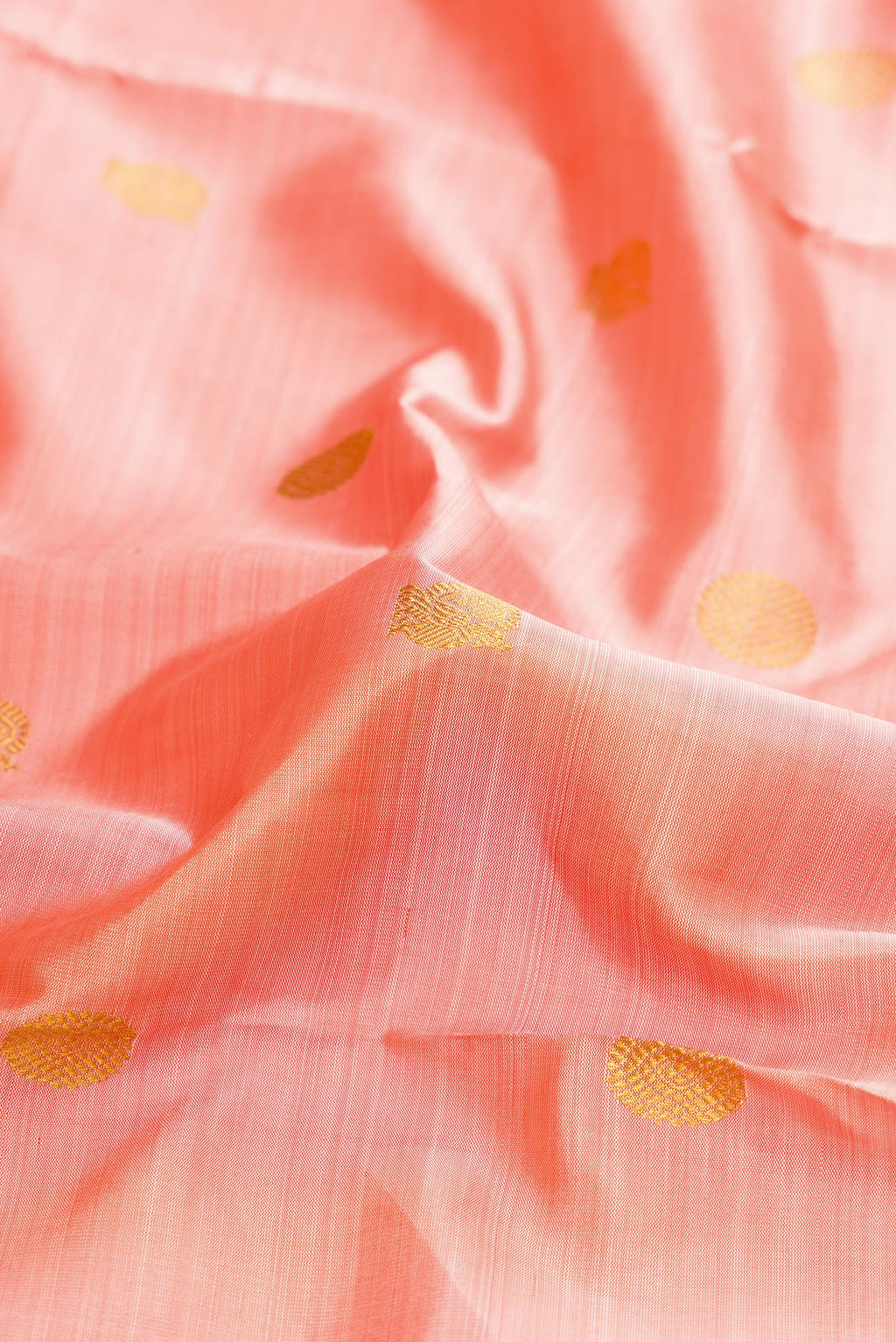 Close up of Pure Silk Pure Zari Peach Dual Tone Kanchipuram Nine Yards Saree with Zari Butta on the body and Zari Border.  displaying folds