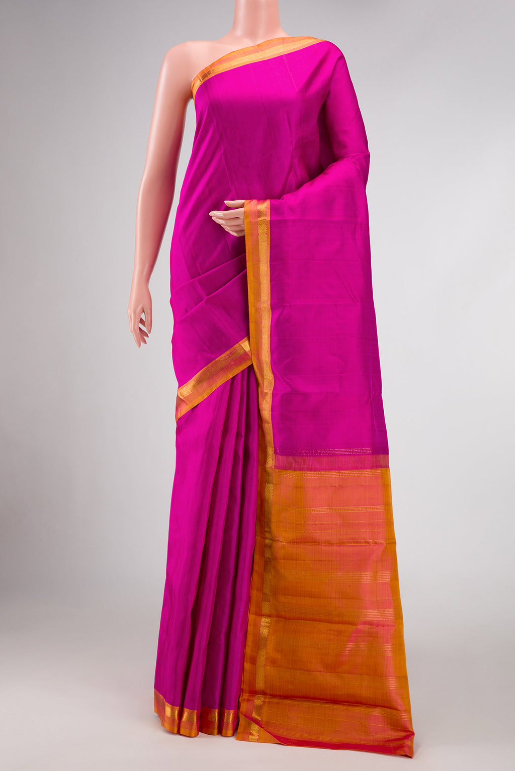 Magenta Dual Tone Kanjivaram Silk Saree with Plain Body and Zari Border.  displayed on a mannequin
