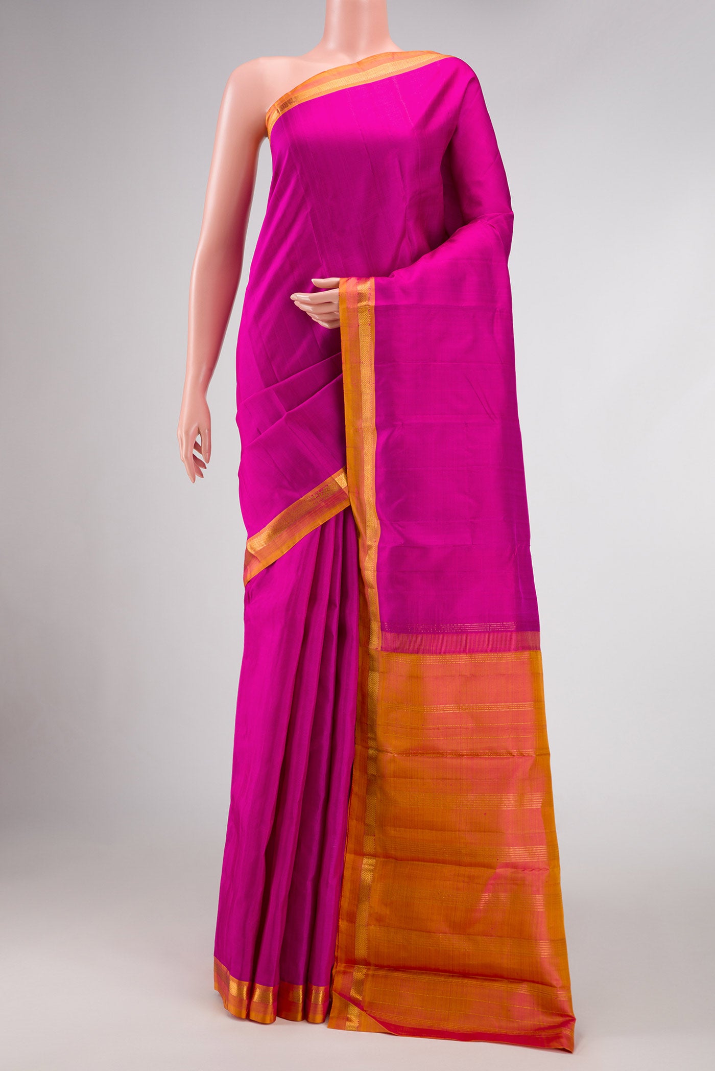 Magenta Dual Tone Kanjivaram Silk Saree with Plain Body and Zari Border.  displayed on a mannequin