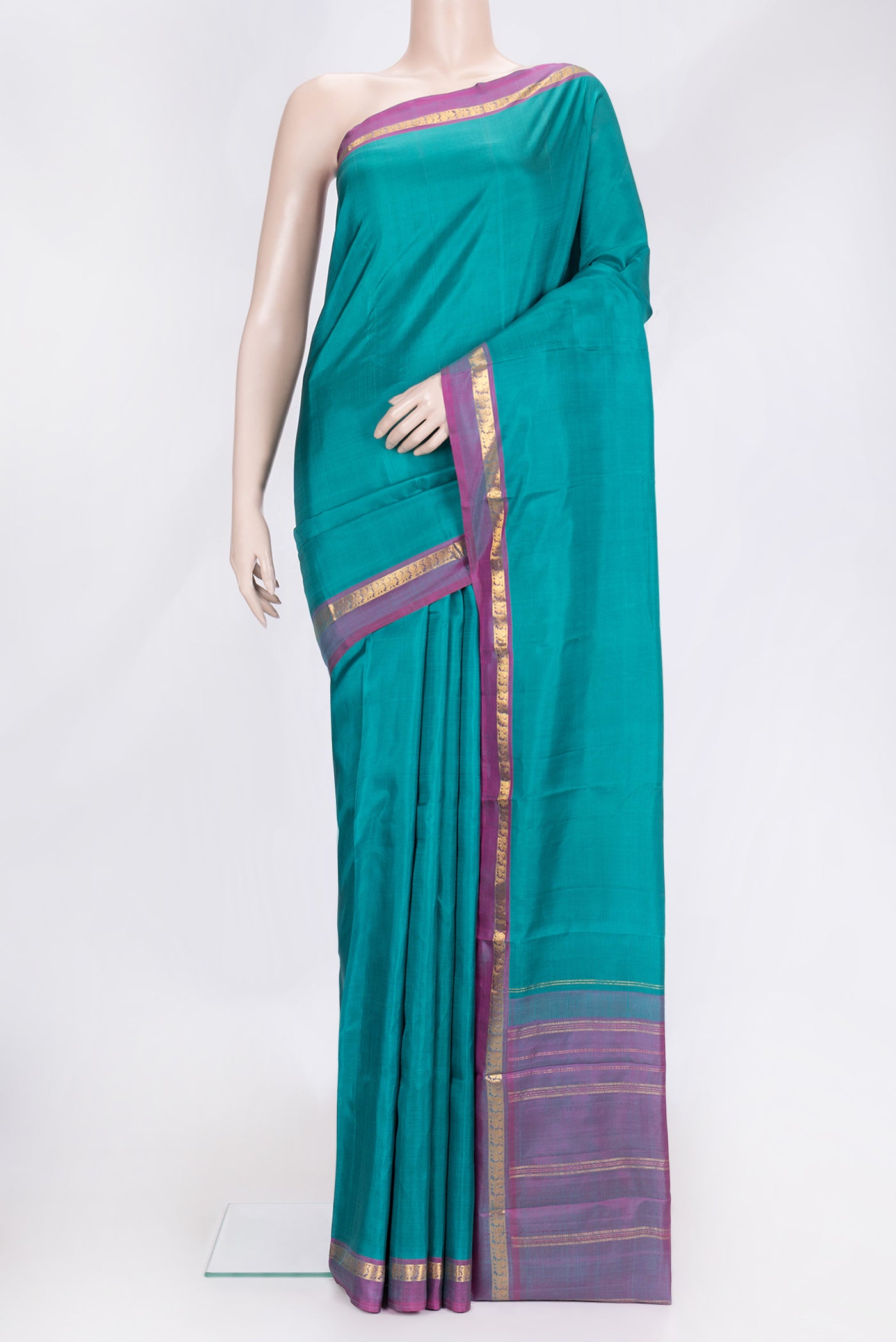 Green Dual Tone Kanjivaram Silk Saree with Plain Body and Zari Border.  displayed on a mannequin