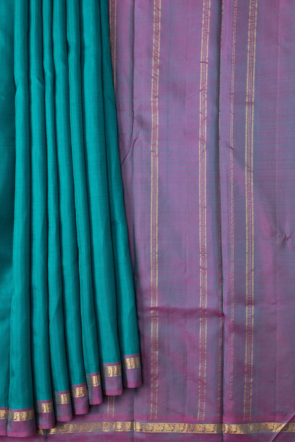 Pleats and pallu of Green Dual Tone Kanjivaram Silk Saree with Plain Body and Zari Border. 