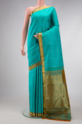 Sea Green Dual Tone Kanchipuram Silk Saree with Zari Butta on the body and Zari Border.  displayed on a mannequin