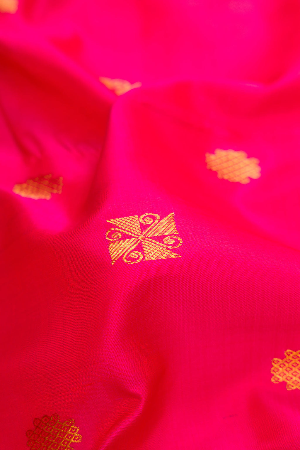 Close up of Pink Dual Tone Kanchipuram Silk Saree with Zari Butta on the body and Zari Border.  displaying folds