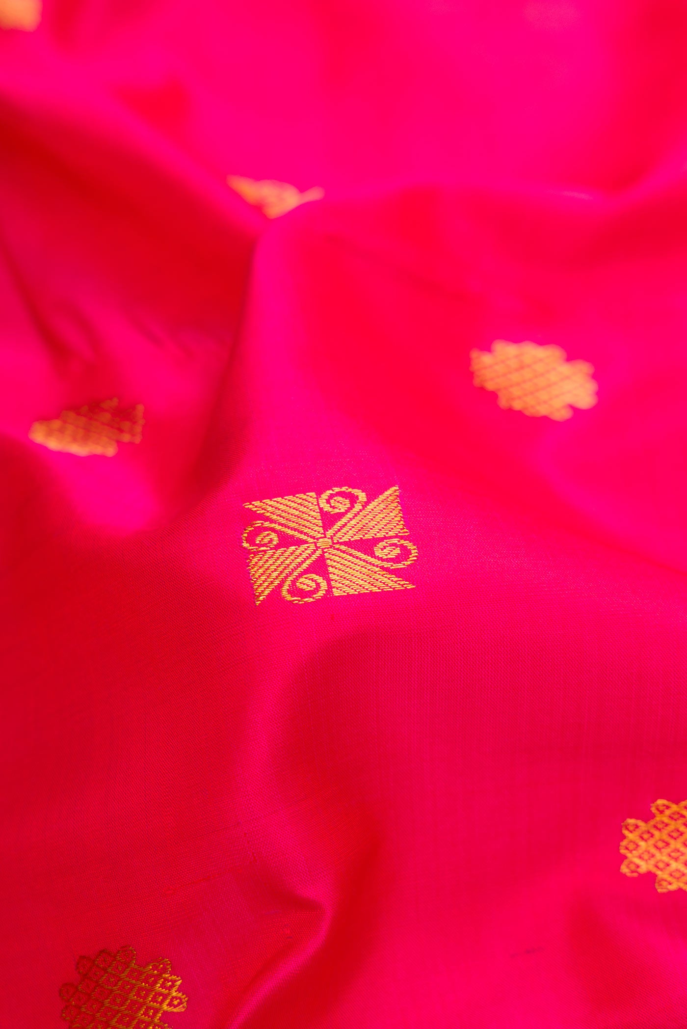 Close up of Pink Dual Tone Kanchipuram Silk Saree with Zari Butta on the body and Zari Border.  displaying folds