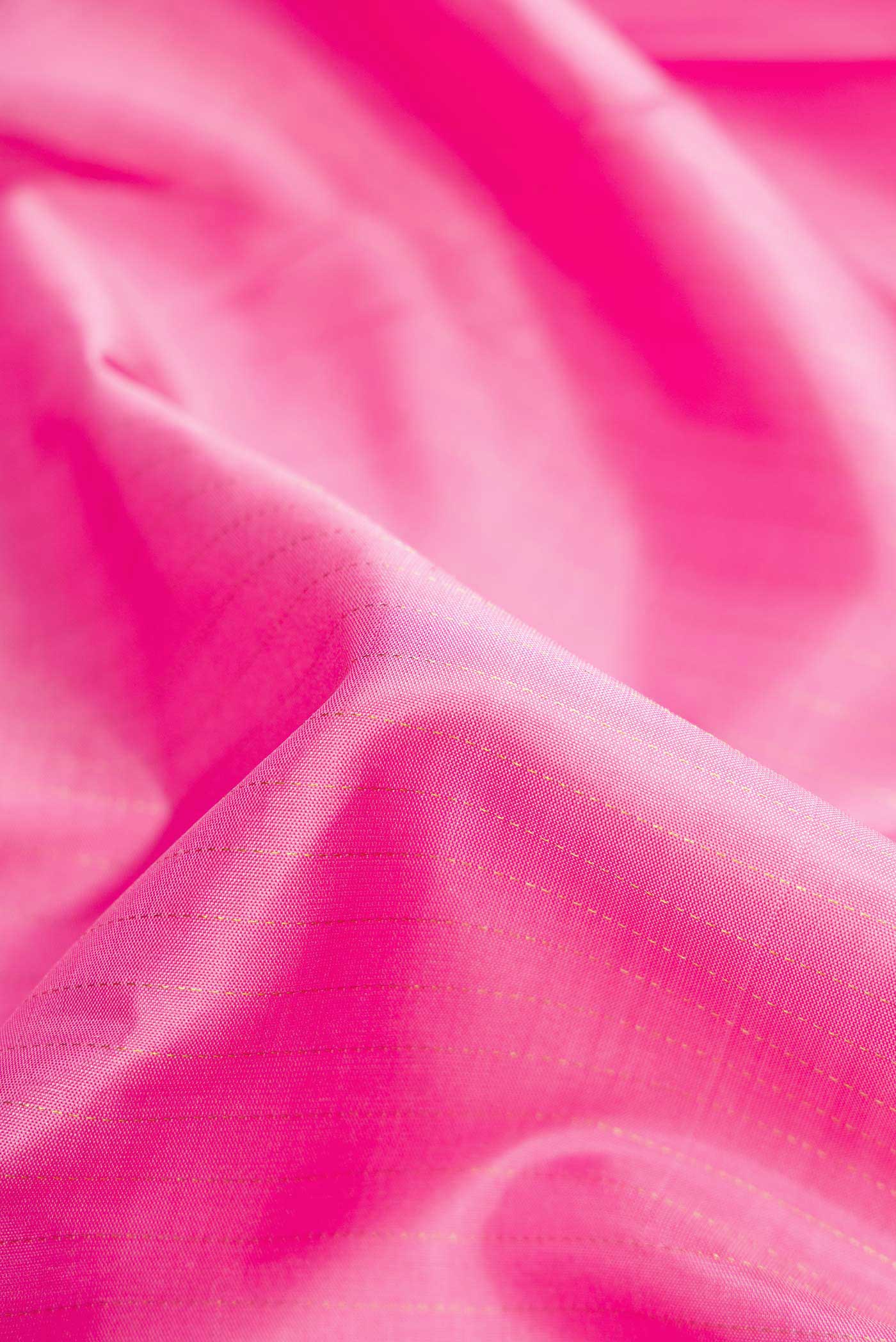 Close up of Pink Dual Tone Kanjivaram Silk Saree with Stripes on the body and Zari Border.  displaying folds