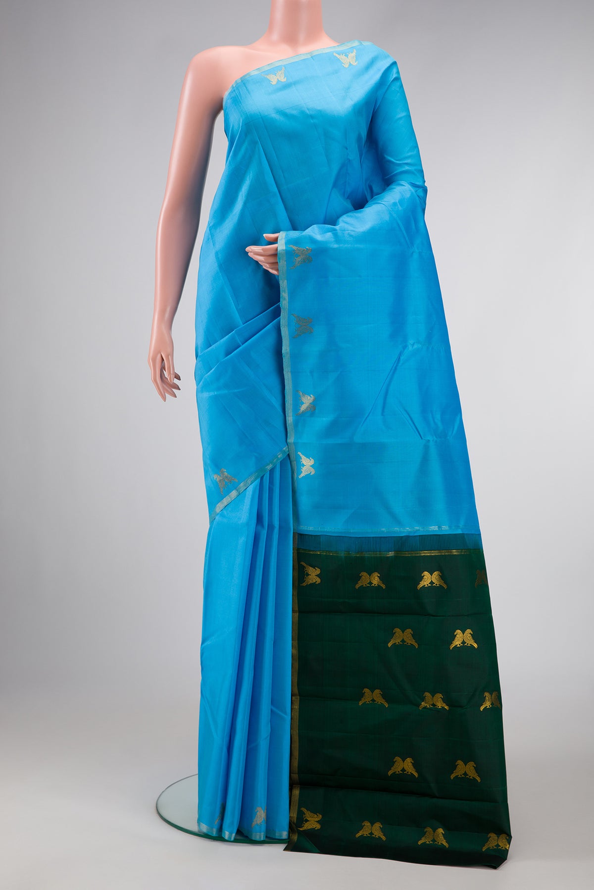 Sky Blue Dual Tone Kanchipuram Silk Saree with Plain Body and Fancy Border.  displayed on a mannequin
