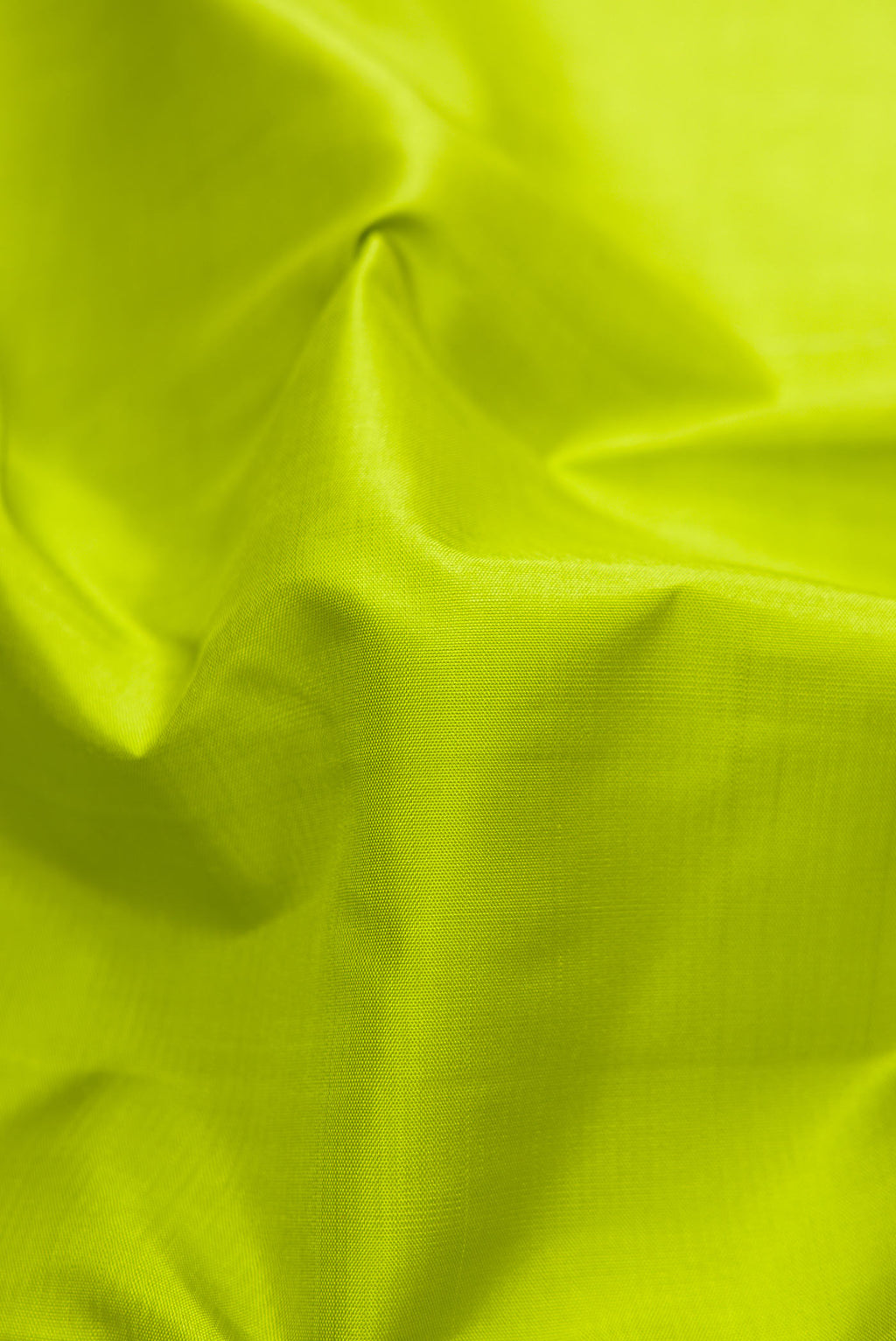 Close up of Green Dual Tone Kanjivaram Silk Saree with Plain Body and Zari Border.  displaying folds