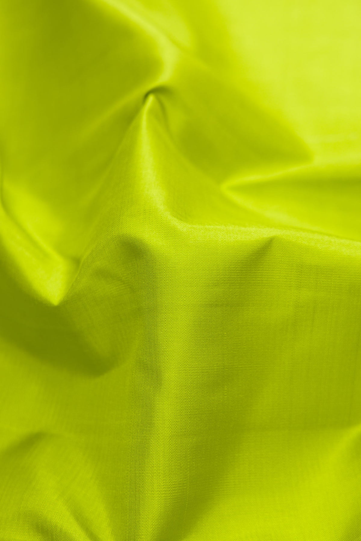 Close up of Green Dual Tone Kanjivaram Silk Saree with Plain Body and Zari Border.  displaying folds