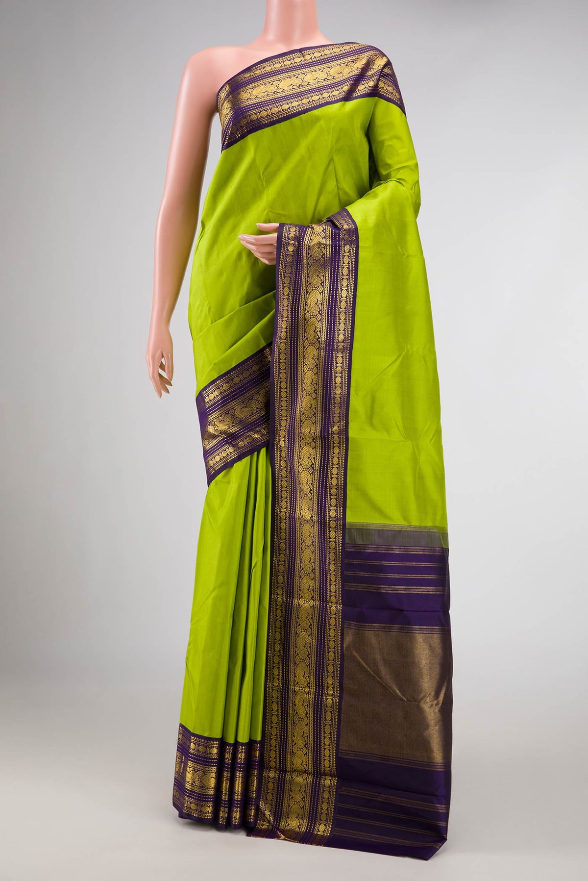 Green Dual Tone Kanjivaram Silk Saree with Plain Body and Zari Border.  displayed on a mannequin