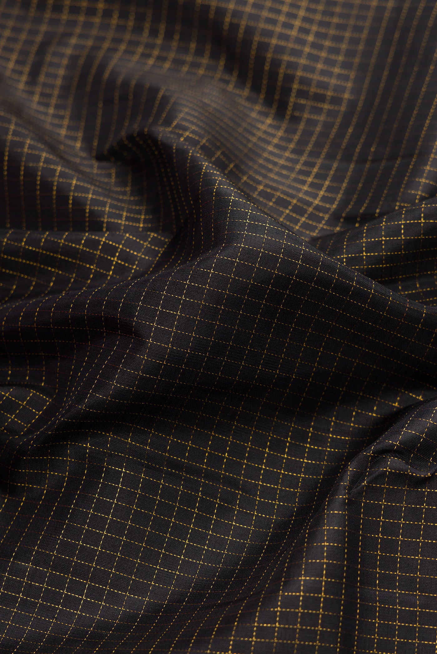 Close up of Black Dual Tone Kanjivaram Silk Saree with Checked design on the body and Ganga Jamuna Border.  displaying folds