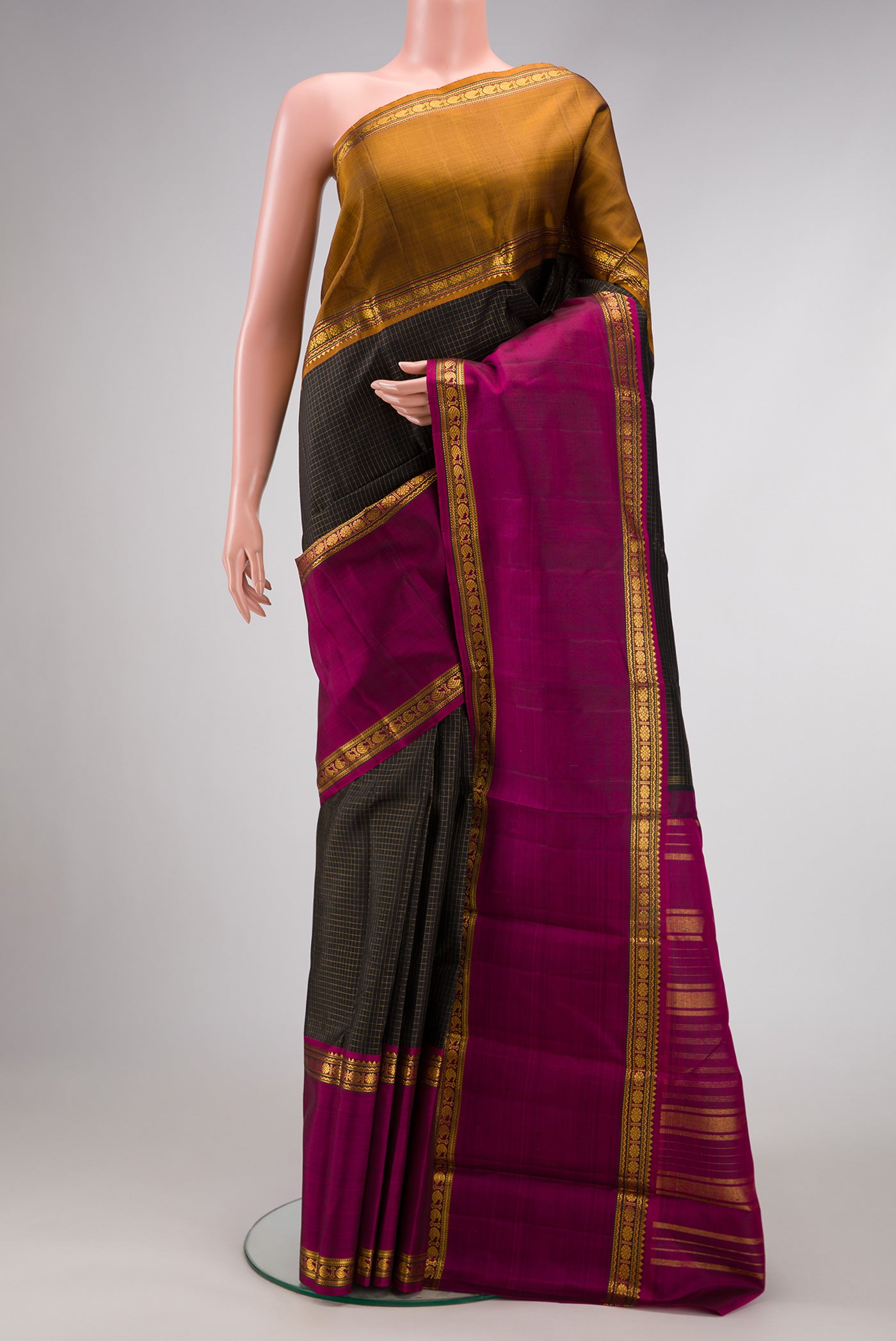 Black Dual Tone Kanjivaram Silk Saree with Checked design on the body and Ganga Jamuna Border.  displayed on a mannequin