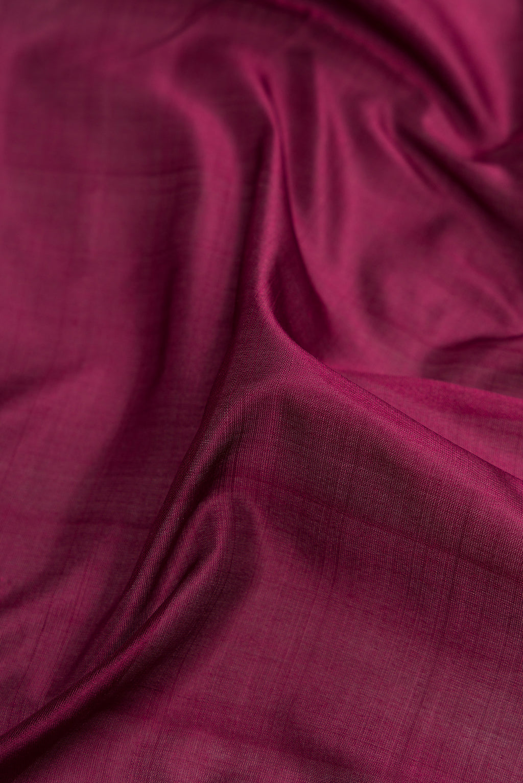 Close up of Burgundy Dual Tone Kanjivaram Silk Nine Yards Saree with Plain Body and Zari Border.  displaying folds